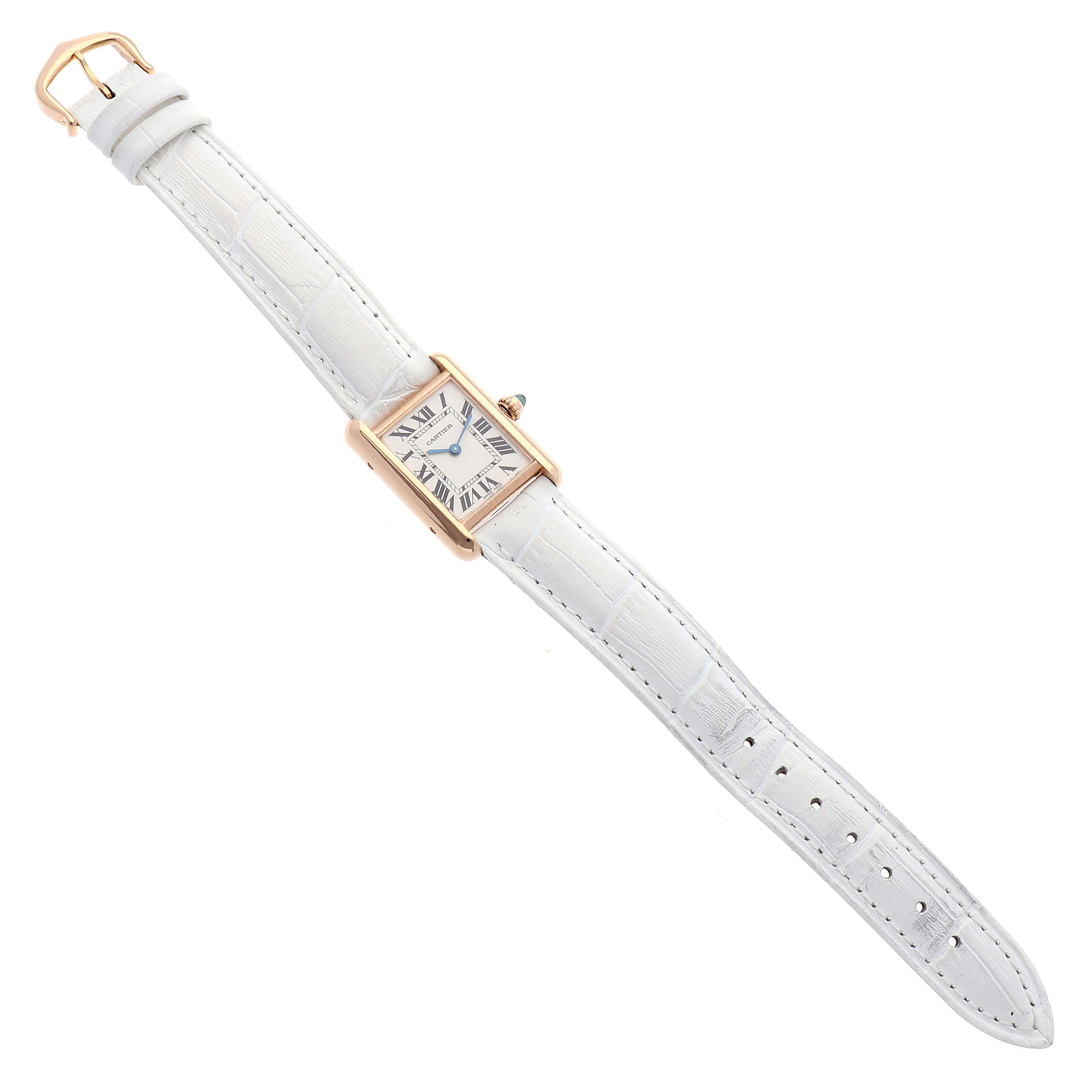 The image shows a top-down view of a Cartier Tank Louis W1529856 Women
s Yellow Gold Silver Dial W1529856 Women
s Yellow Gold Silver Dial watch, featuring a rectangular case and a white leather strap.