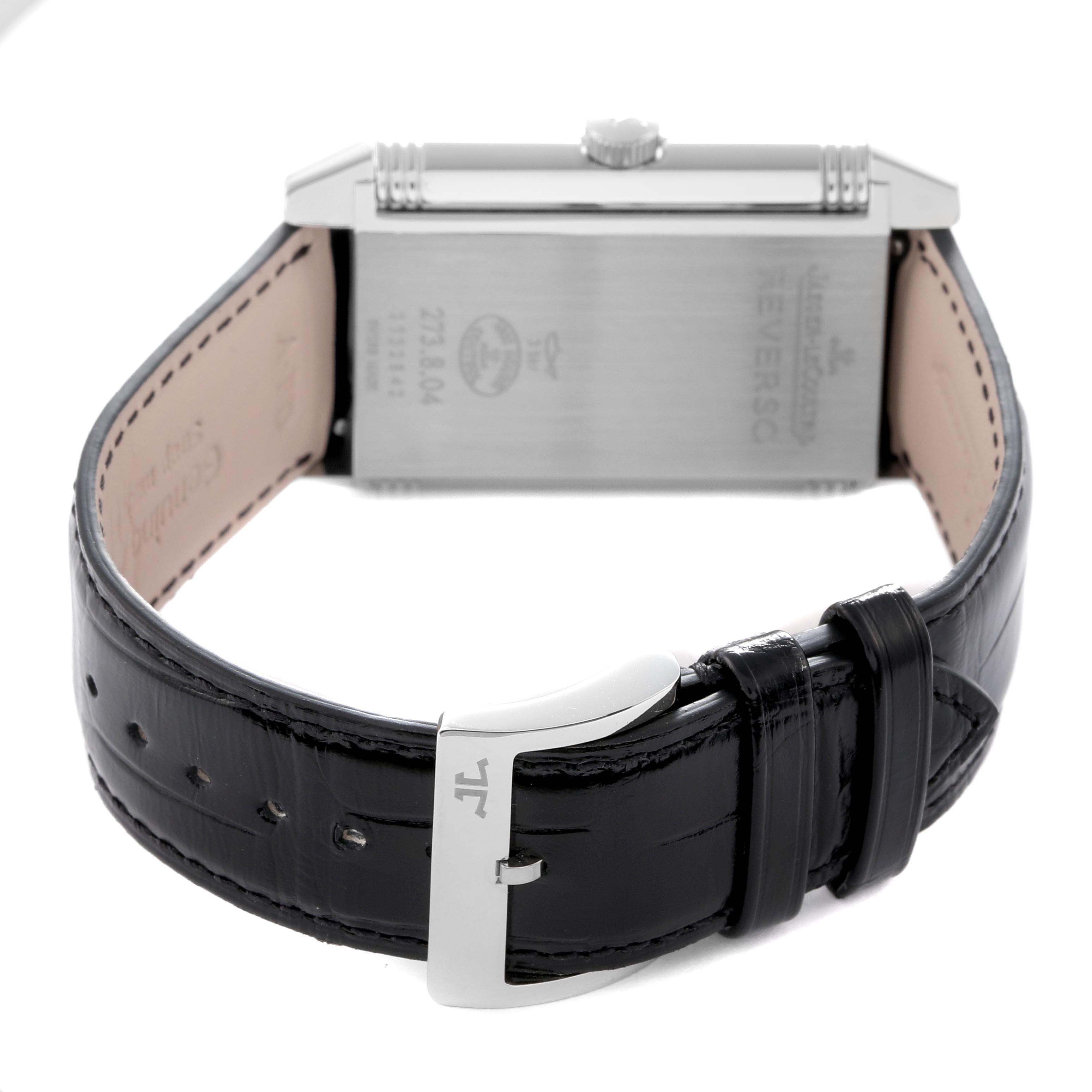 The Jaeger LeCoultre Reverso model Q3738420 is shown from the back, highlighting the case back, crown, leather strap, and buckle.