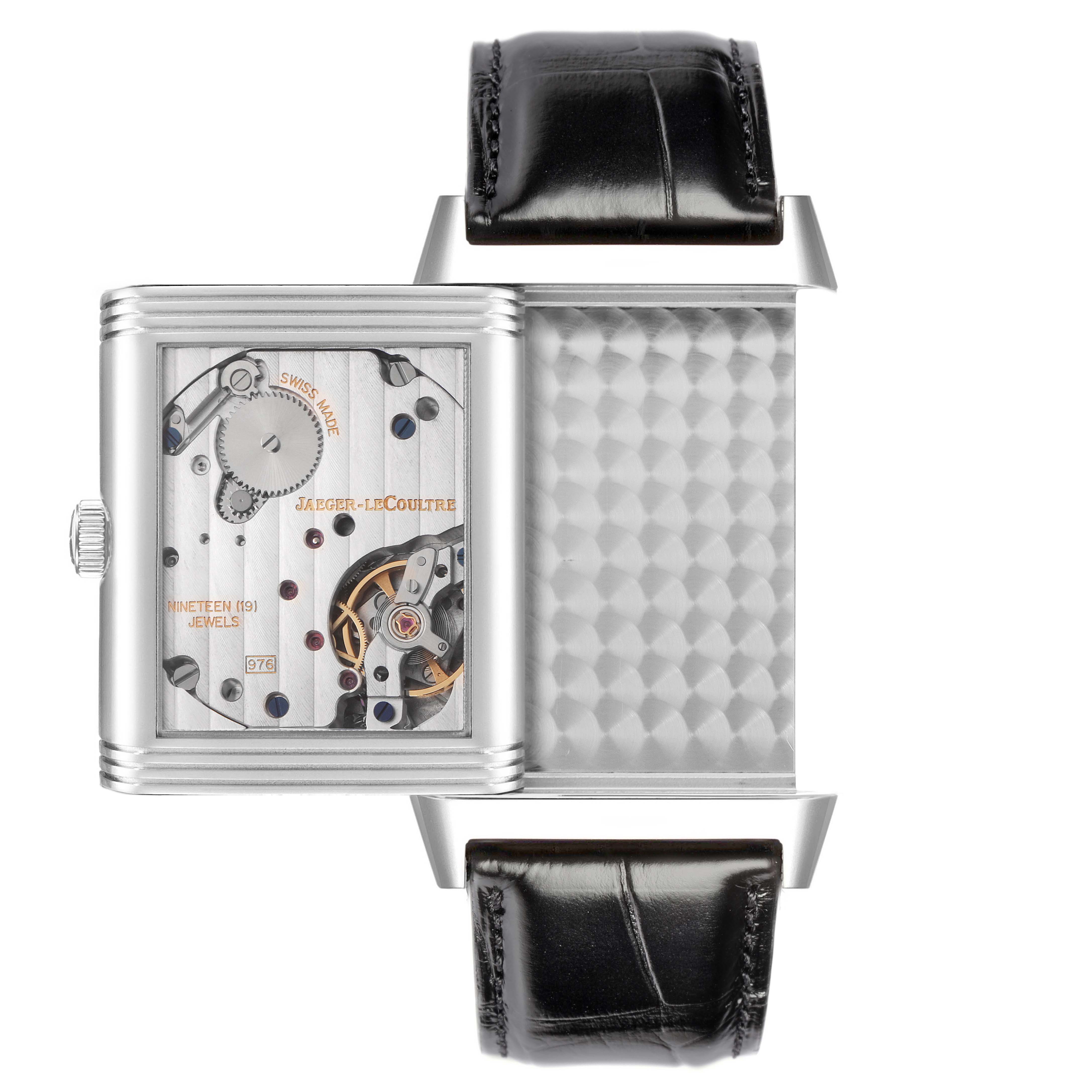The Jaeger LeCoultre Reverso Q3738420 watch is shown with a view of its inner mechanism, featuring the case flipped to reveal intricate gears and components.