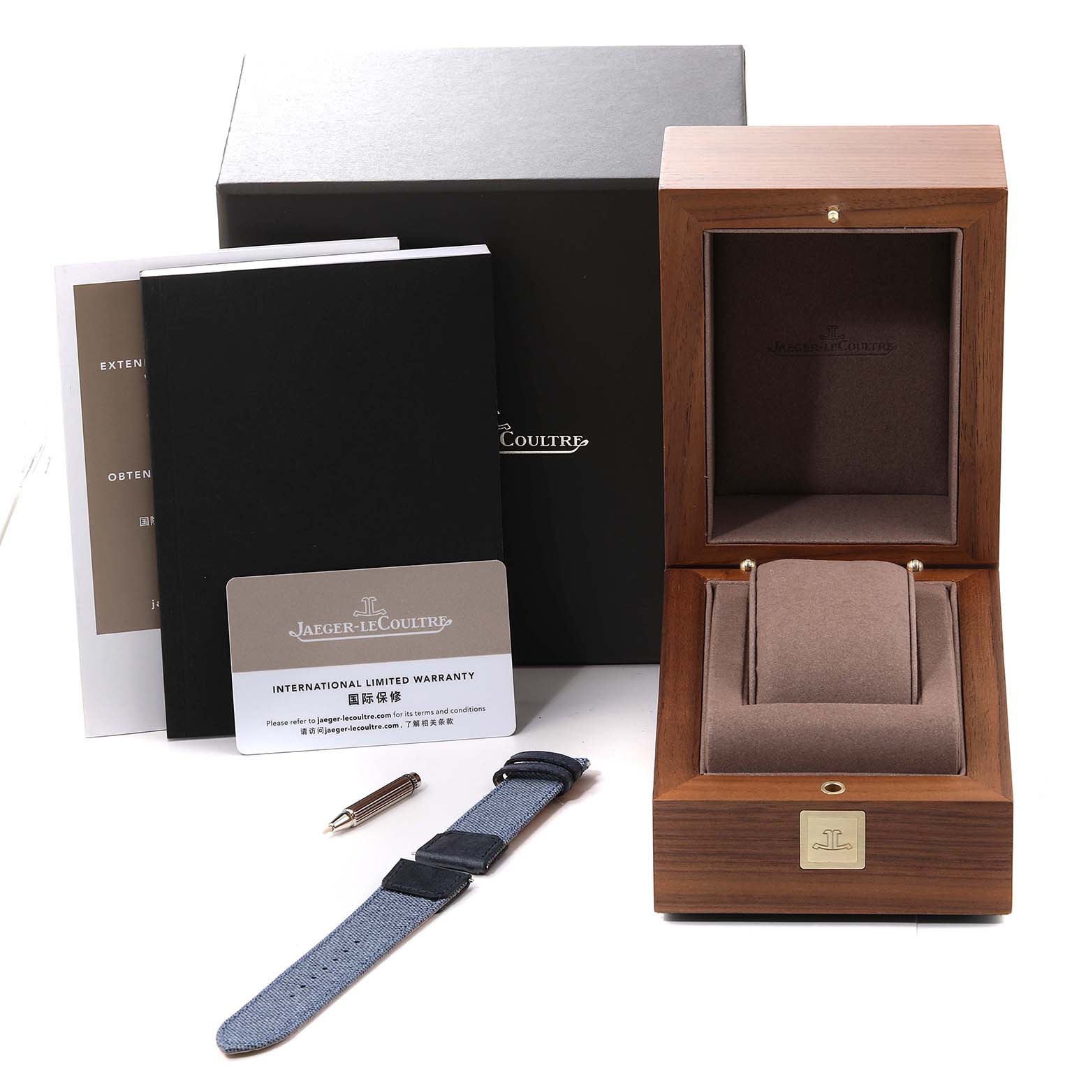 This image shows a Jaeger LeCoultre Reverso Q3918420 Men's Stainless Steel Blue Dial Q3918420 Men's Stainless Steel Blue Dial watch's accessories, including a wooden box, straps, international warranty, and manuals.