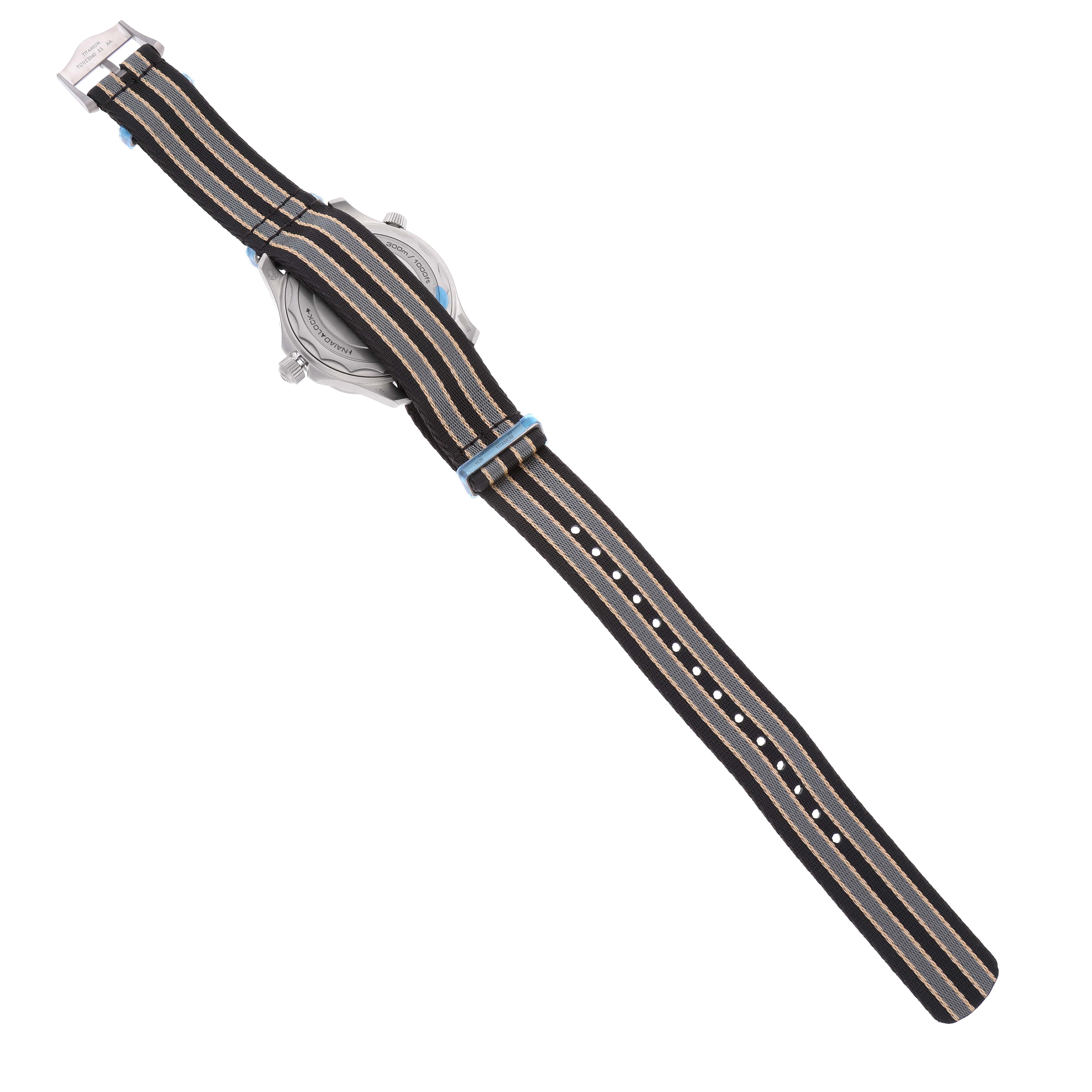 The image shows the rear view of an Omega Seamaster 210.92.42.20.01.001 Men's Titanium Brown Dial 210.92.42.20.01.001 Men's Titanium Brown Dial watch, focusing on its striped fabric strap.