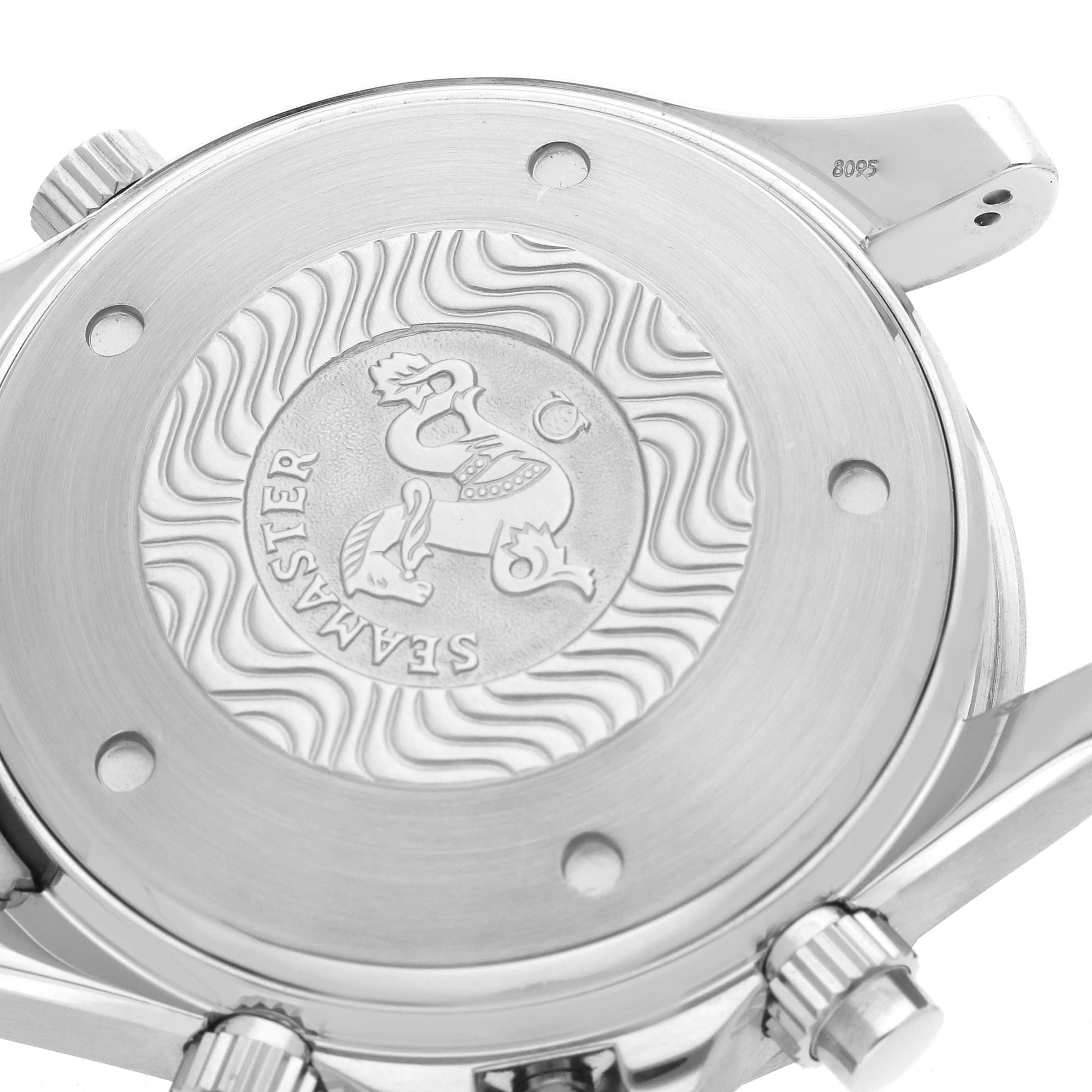 The image shows the case back of an Omega Seamaster model 2599.80.00, featuring the Seamaster engraving and visible crown and pushers at an angled view.