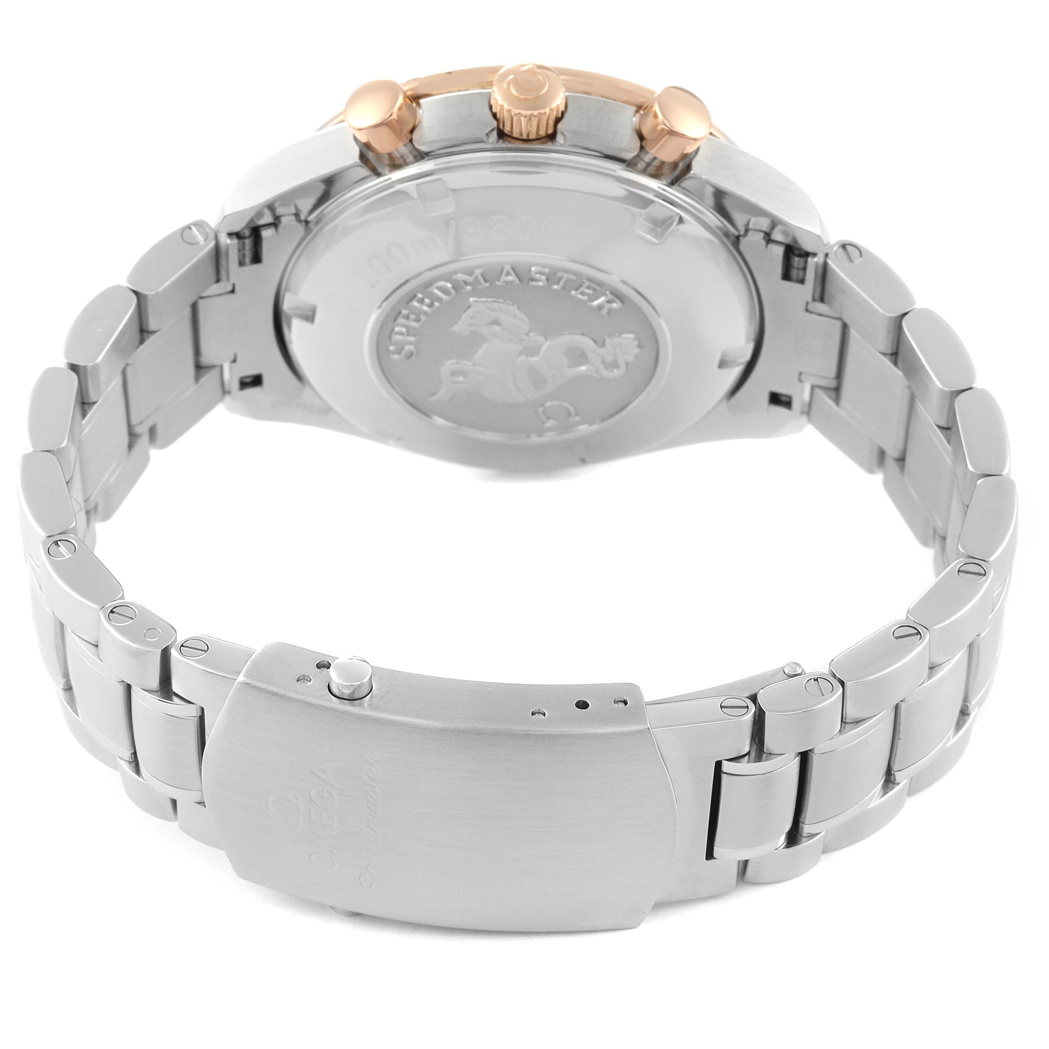 The image shows the back and clasp of an Omega Speedmaster 323.21.40.40.01.001 Men's Steel and Gold (two tone) Black Dial 323.21.40.40.01.001 Men's Steel and Gold (two tone) Black Dial watch, highlighting the bracelet and case back with the engraved logo.