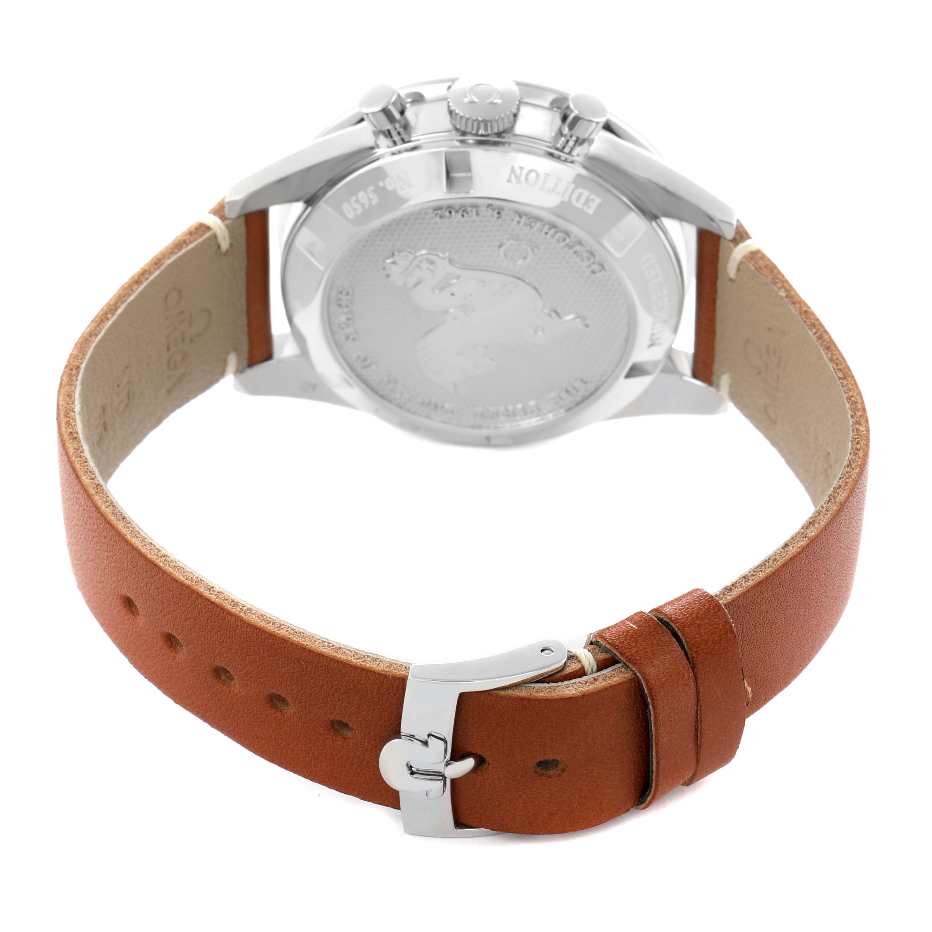 The image shows the backside of an Omega Speedmaster model 311.32.40.30.01.001, highlighting the case back and brown leather strap with a clasp.