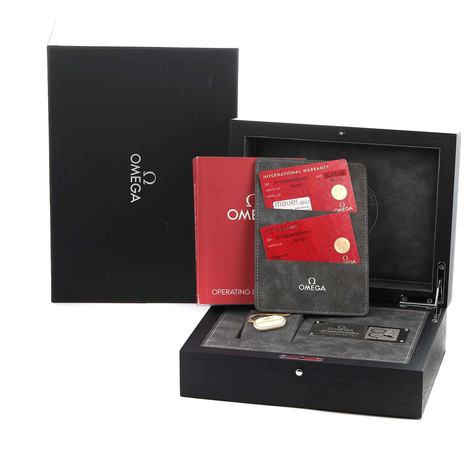 The image shows an Omega Speedmaster model 311.32.40.30.01.001 watch box, warranty cards, user manual, and packaging from a front angle.