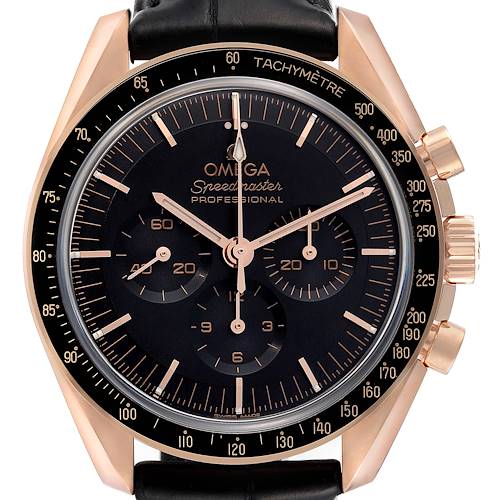 The Omega Speedmaster watch is shown from a front angle, highlighting its dial, tachymeter, and chronograph features.