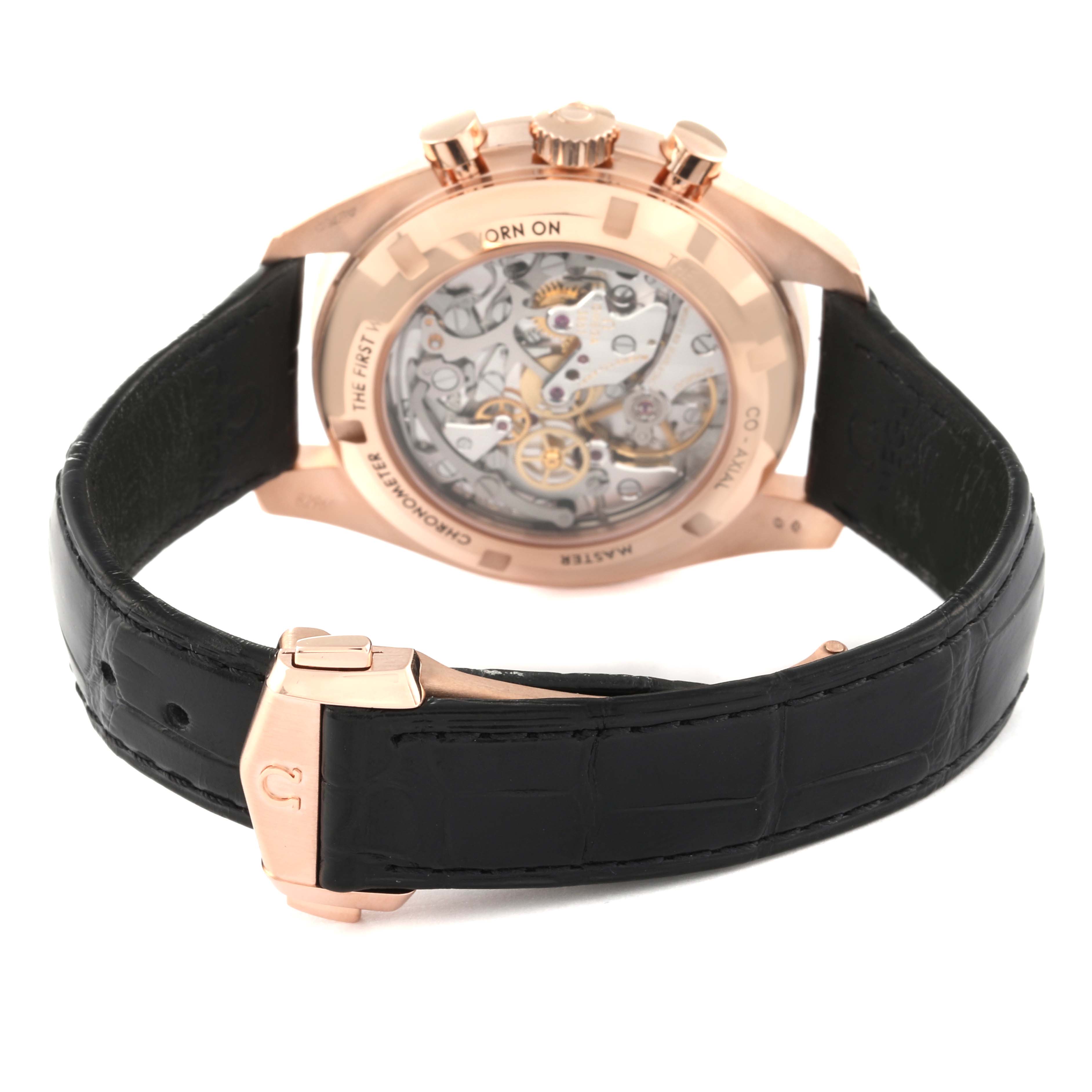 The image shows the back view of an Omega Speedmaster 310.63.42.50.02.001 Men's Rose Gold Black Dial 310.63.42.50.02.001 Men's Rose Gold Black Dial watch, highlighting the transparent case back and leather strap.