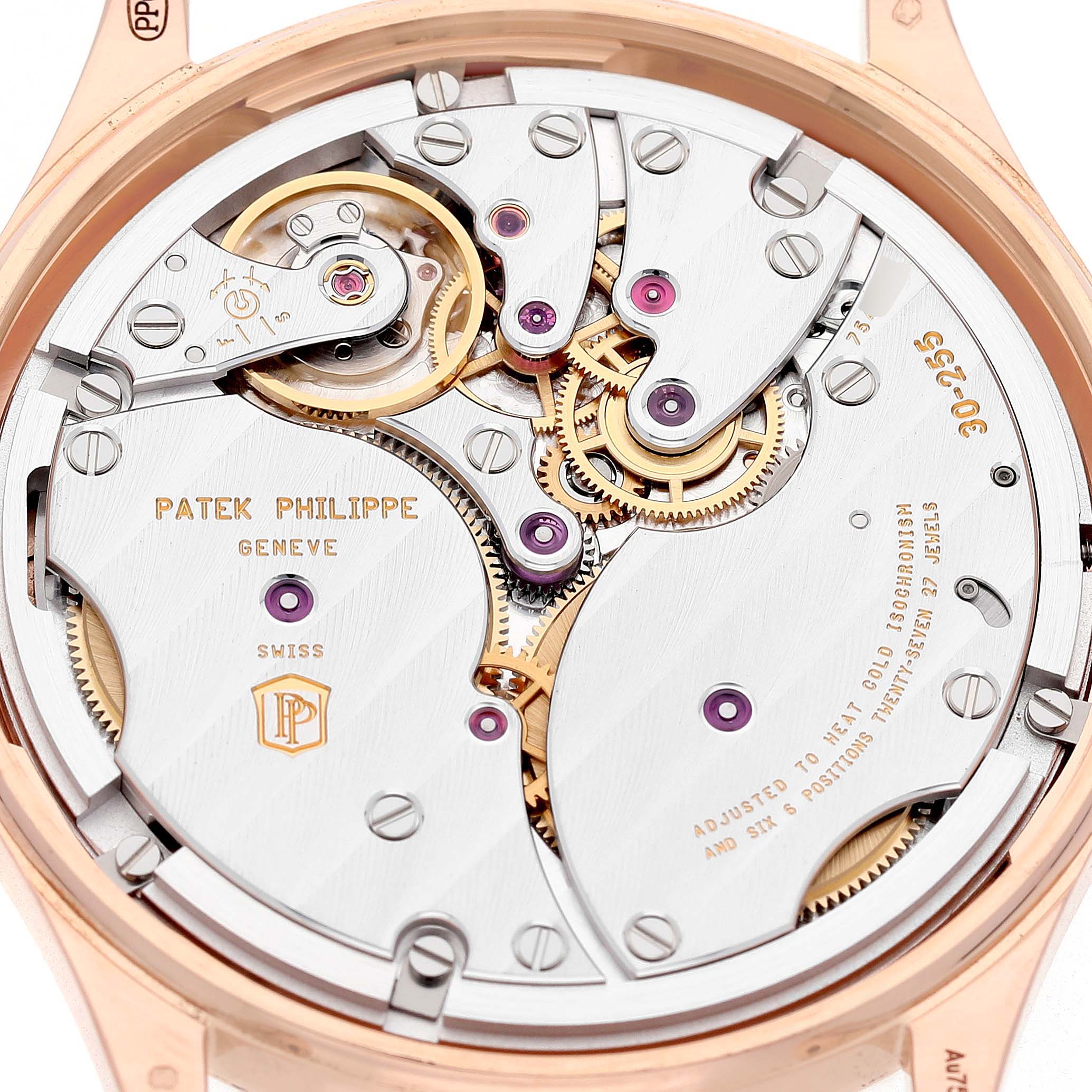 The image shows the movement and intricate mechanisms of the Calatrava model by Patek Philippe from its back side.