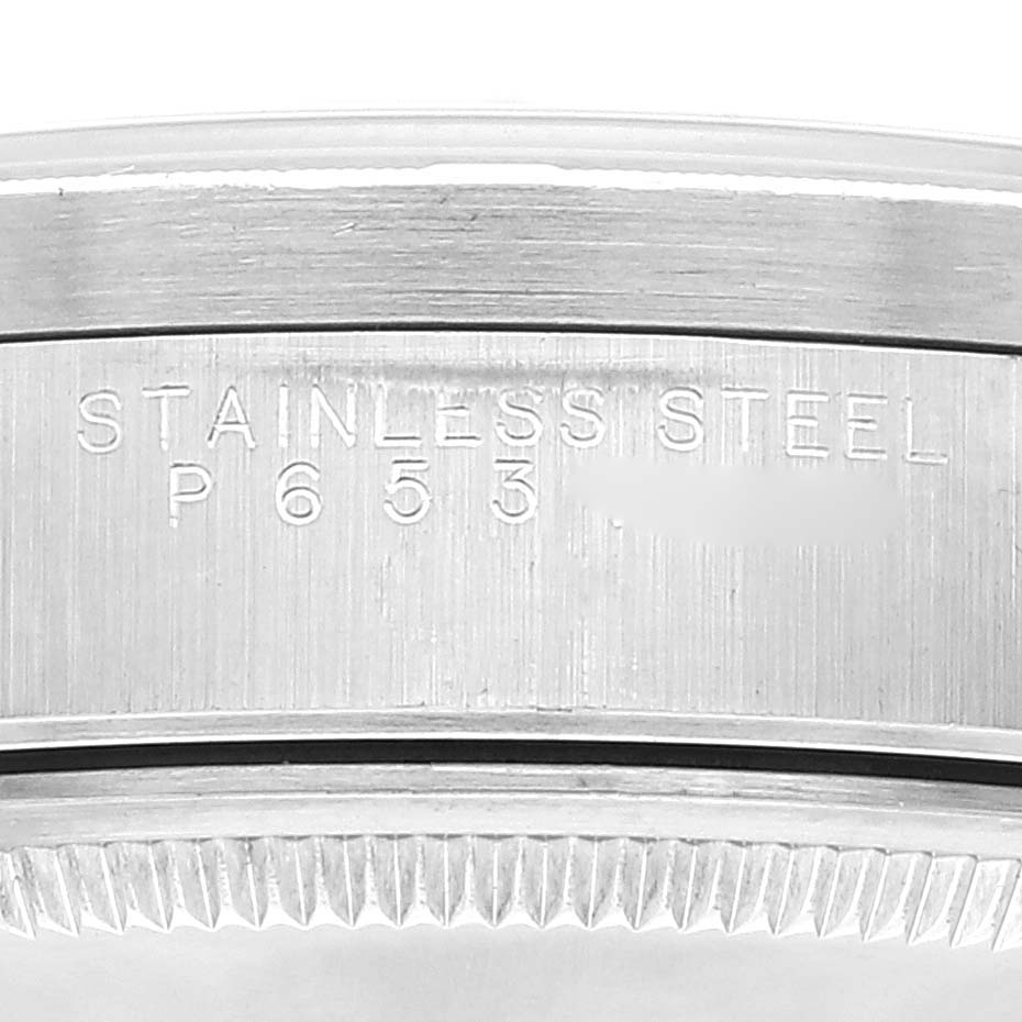This image shows an angled close-up view of the stainless steel case back of a Rolex Air-King 14010 Men's Stainless Steel Black Dial 14010 Men's Stainless Steel Black Dial watch.