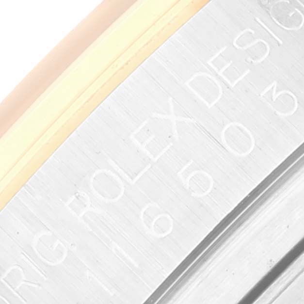 Close-up of the case side of a Rolex Daytona 116503 Men's Steel and Gold (two tone) Champagne Dial 116503 Men's Steel and Gold (two tone) Champagne Dial, focusing on the engraved writing and part of the bezel.