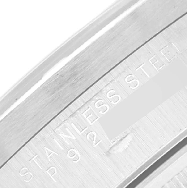 The image shows a close-up of the case back of a Rolex Date 15210 Men's Stainless Steel Black Dial 15210 Men's Stainless Steel Black Dial model, highlighting the "STAINLESS STEEL" engraving.