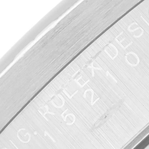 This image shows an angled close-up of the engraving on the side of the bezel of a Rolex Date 15210 Men's Stainless Steel Black Dial 15210 Men's Stainless Steel Black Dial model watch.