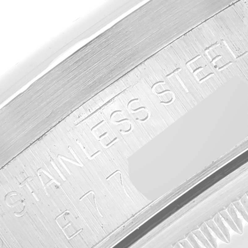 This close-up image shows the stainless steel engraving on the casing of a Rolex Date 15210 Men's Stainless Steel Silver Dial 15210 Men's Stainless Steel Silver Dial model watch.