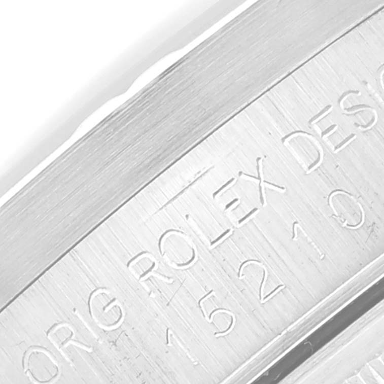 The image shows a close-up of the engraved side of a Rolex Date 15210 Men's Stainless Steel Silver Dial 15210 Men's Stainless Steel Silver Dial watch with model information.