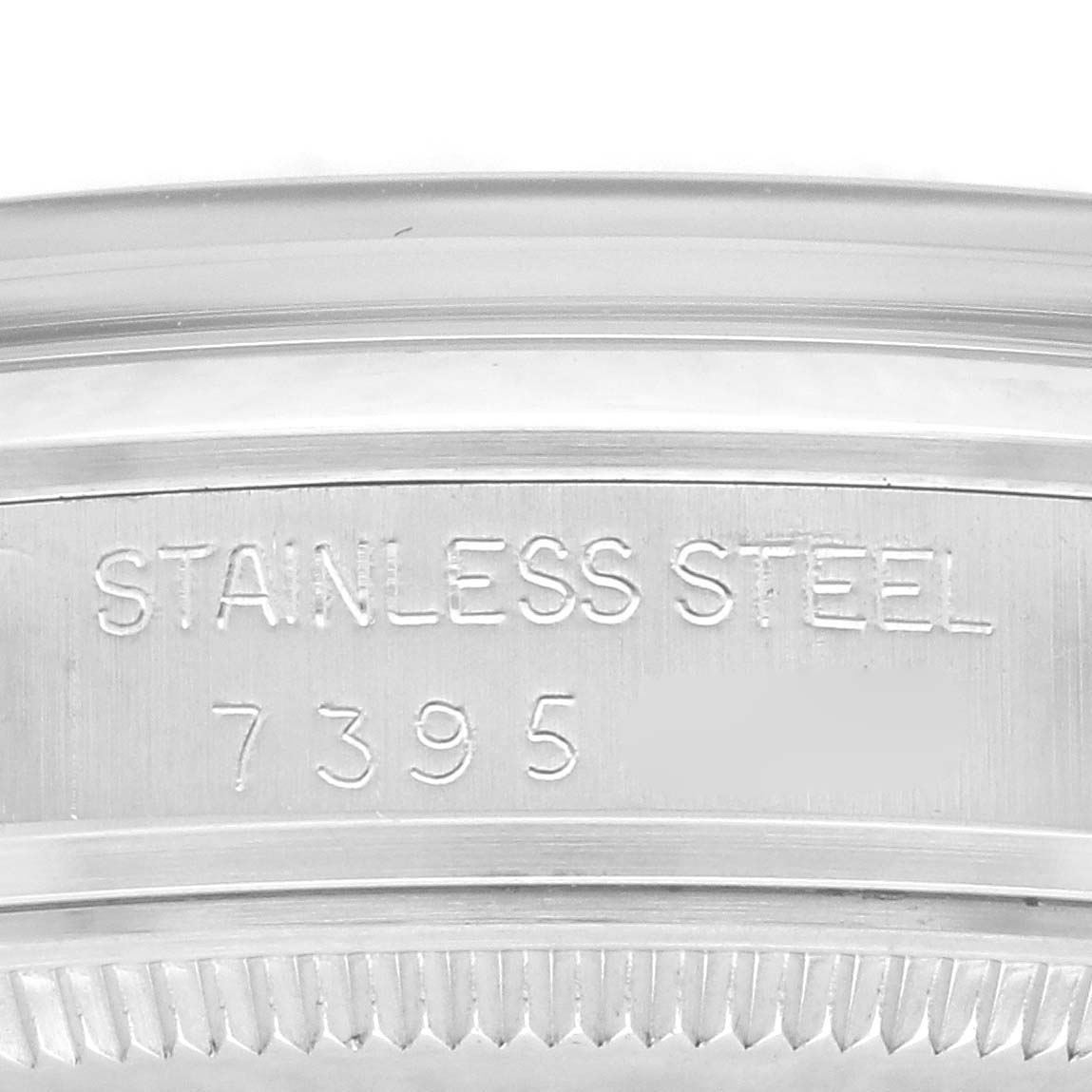 The image shows a close-up of the stainless steel case back of a Vintage Collection Rolex watch, displaying the material and model number.