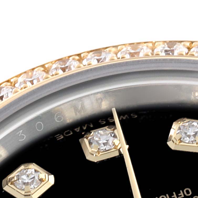 The image shows a close-up of the bezel and part of the dial of a Rolex Datejust 179383G Women's Steel and Gold (two tone) Black Dial 179383G Women's Steel and Gold (two tone) Black Dial watch, featuring diamonds and hour markers.