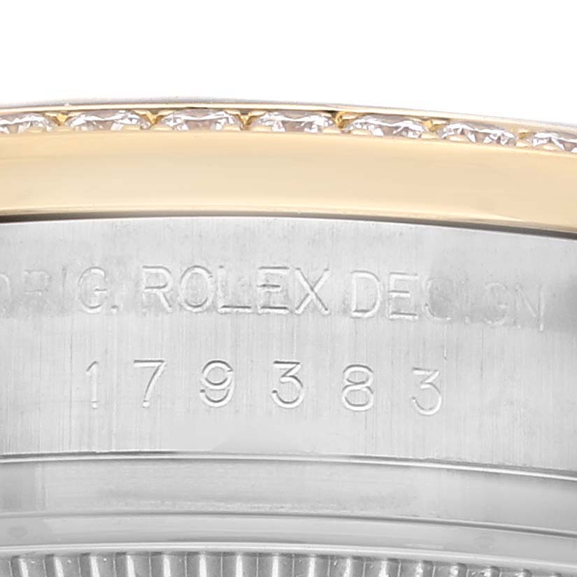 This image shows a close-up of the engraved case side and part of the bezel of a Rolex Datejust 179383G Women's Steel and Gold (two tone) Black Dial 179383G Women's Steel and Gold (two tone) Black Dial.