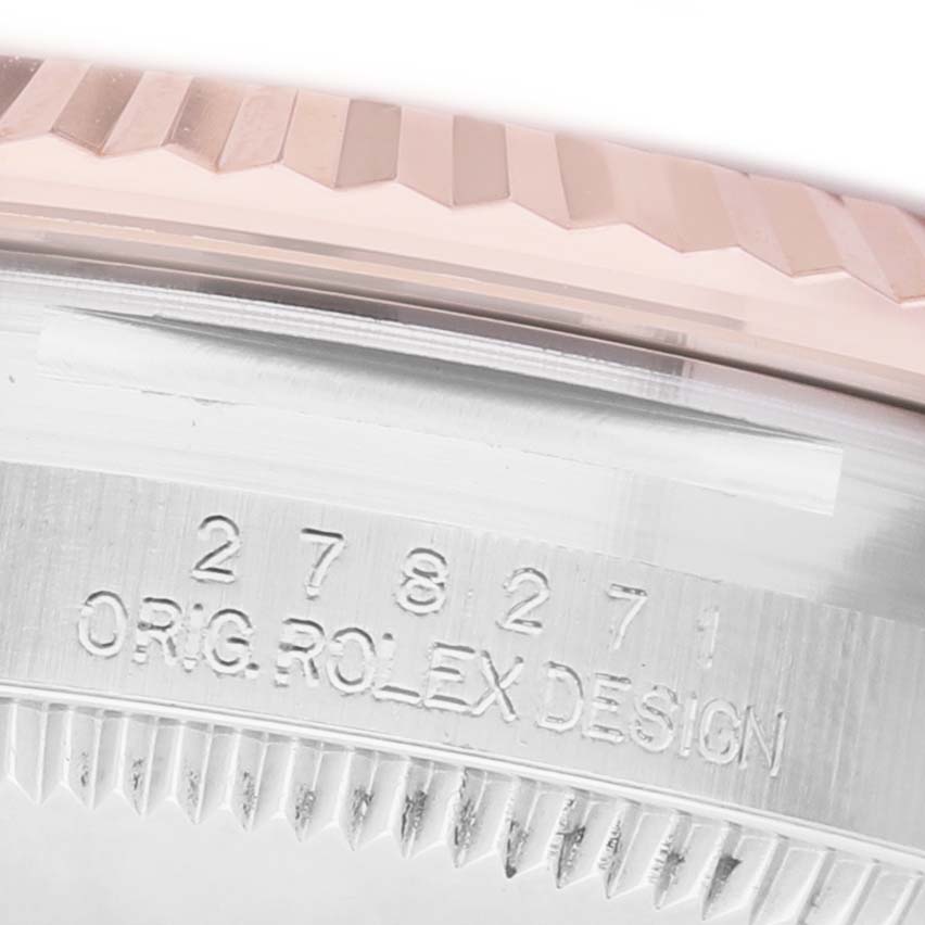 The image shows a close-up of the side of a Rolex Mid-Size 278271 Women's Steel and Gold (two tone) Pink Dial model, displaying the fluted bezel and engraved case details.