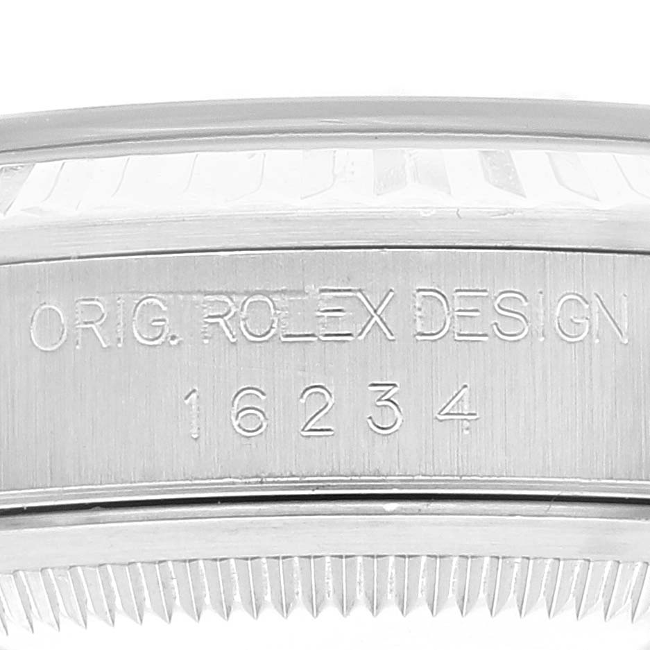 The image shows a close-up of the engraved case and bezel of a Rolex Datejust 16234 Men
s Stainless Steel Pink Dial 16234 Men
s Stainless Steel Pink Dial model.