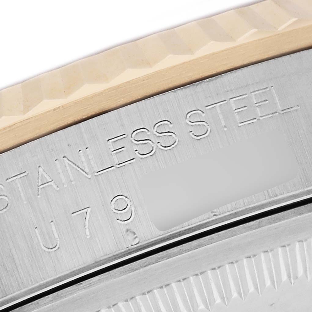 This image shows a close-up of the bezel and part of the case back engraving on a Rolex Datejust 16233 Men's Steel and Gold (two tone) Black Dial 16233 Men's Steel and Gold (two tone) Black Dial watch.