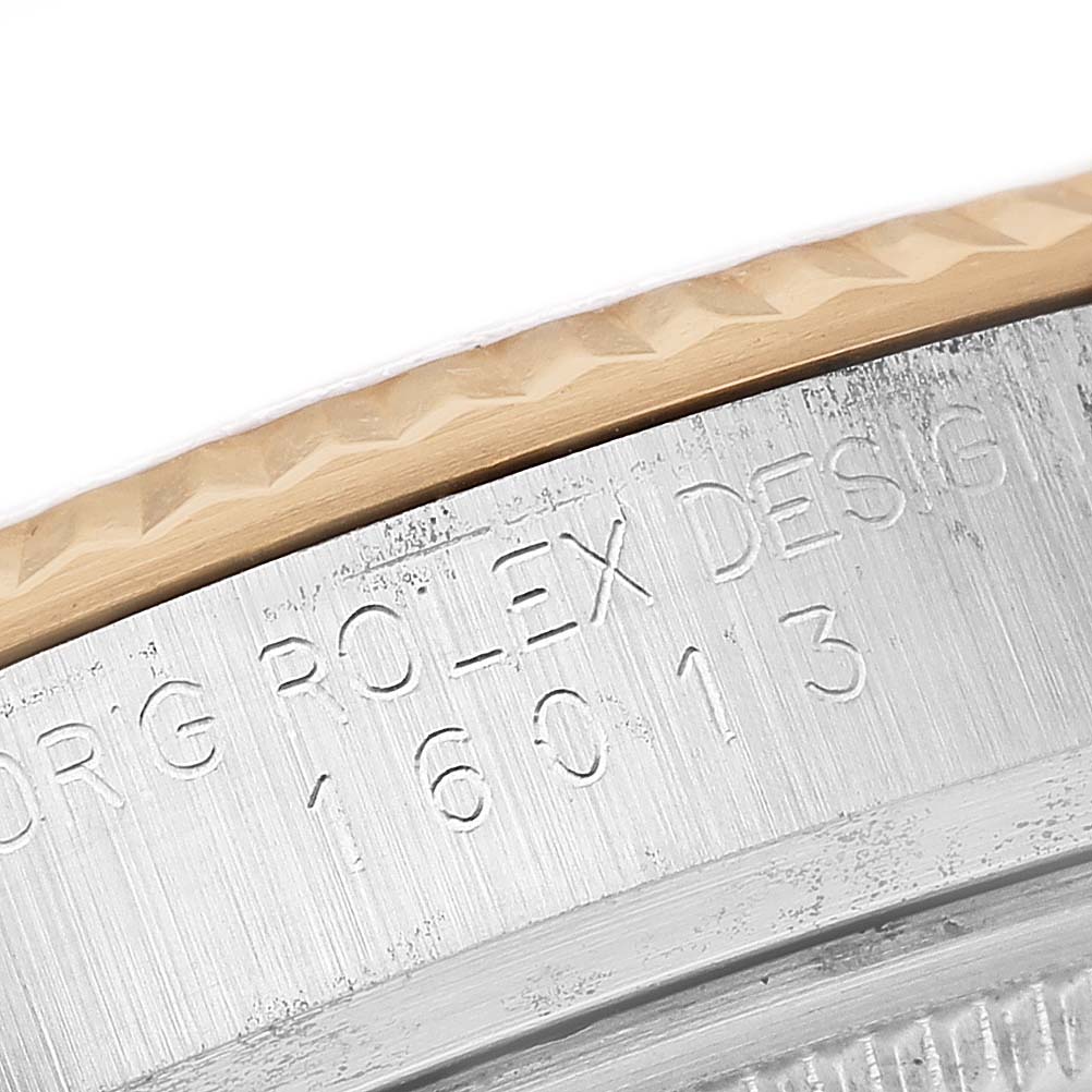 The image shows a close-up of the Rolex Datejust 16013 Men's Steel and Gold (two tone) Champagne Dial bezel and side case, highlighting the engraved serial number.