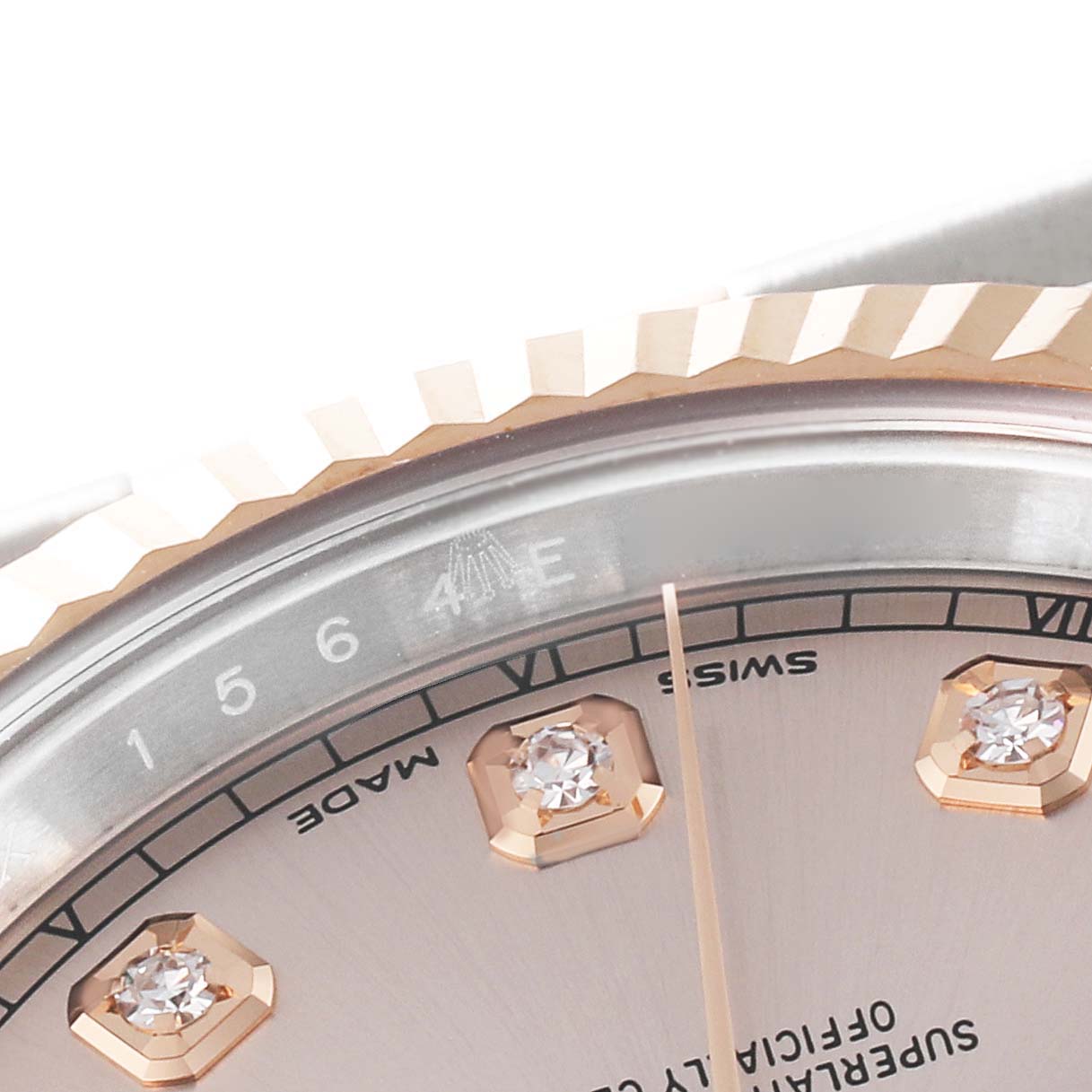 This close-up image of the Rolex Datejust 41 126331 Men's Steel and Gold (two tone) Pink Dial 126331 Men's Steel and Gold (two tone) Pink Dial model shows part of the dial with diamond markers, bezel, and part of the hour marker indicators.