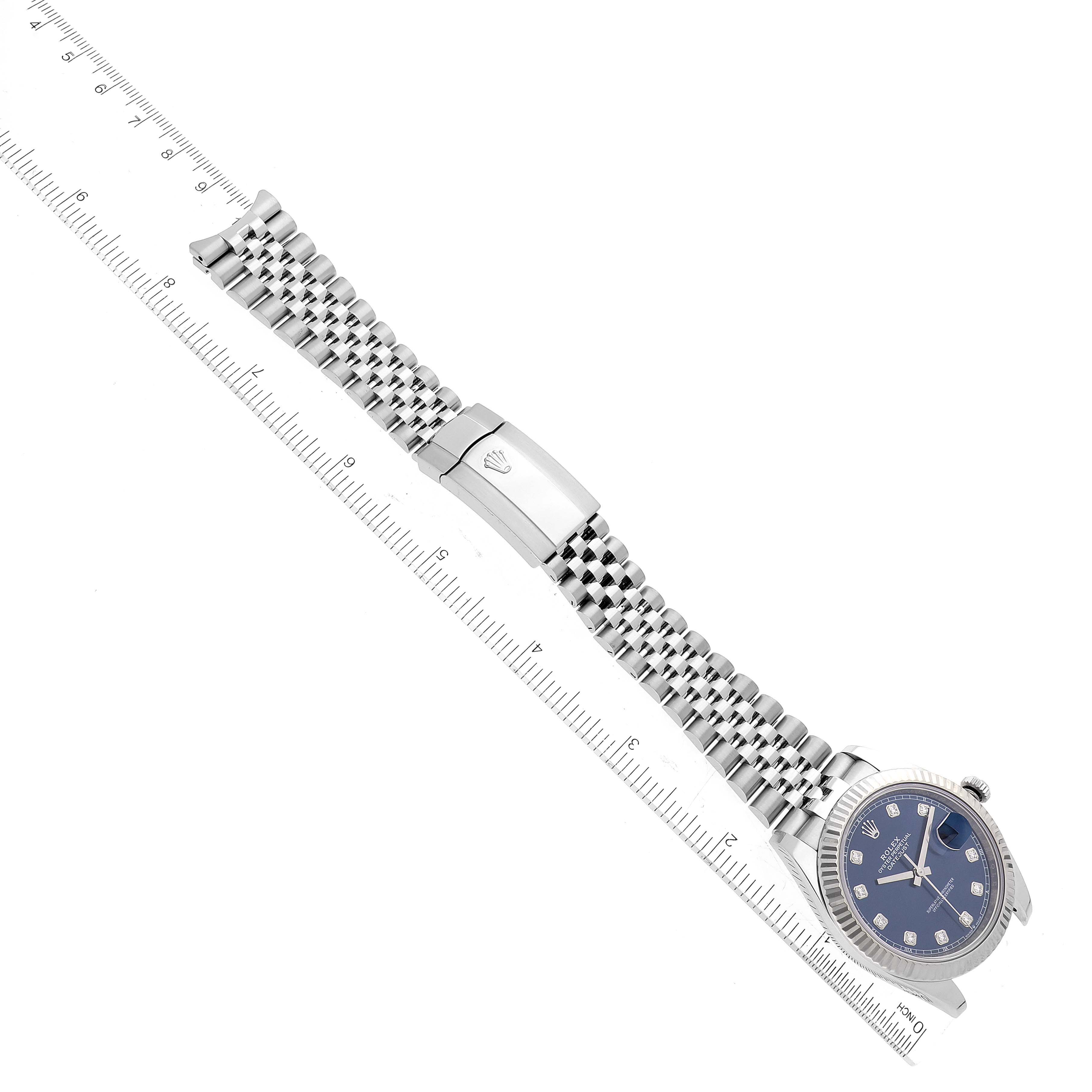 The image shows a top-down view of a Rolex Datejust 41 126334 Men's Stainless Steel Blue Dial 126334 Men's Stainless Steel Blue Dial watch, including the bracelet and clasp, with a ruler for scale.