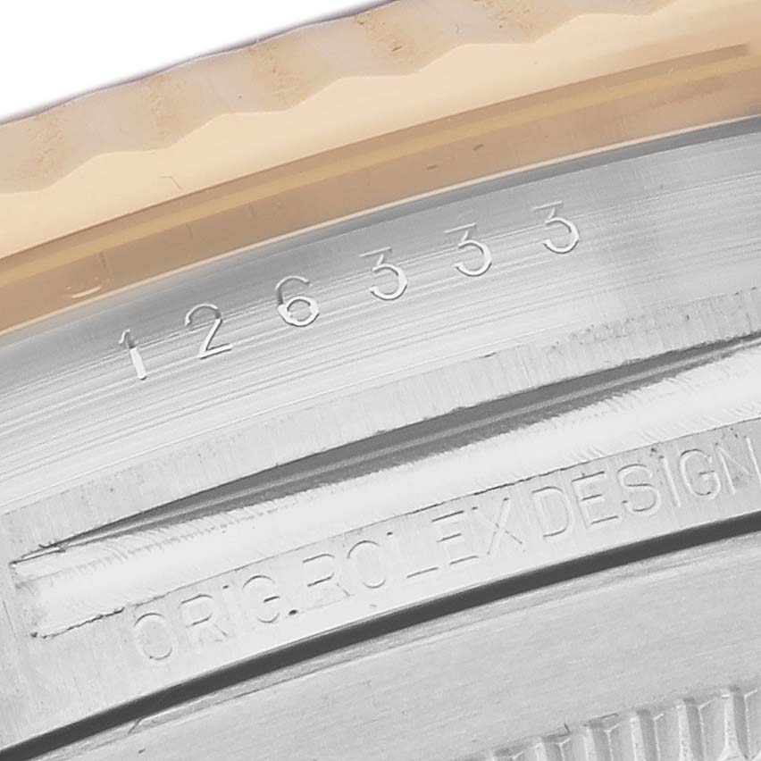 This close-up shows the model number and edge of the bezel of a Rolex Datejust 41 126333 Men's Steel and Gold (two tone) Grey Dial 126333 Men's Steel and Gold (two tone) Grey Dial.