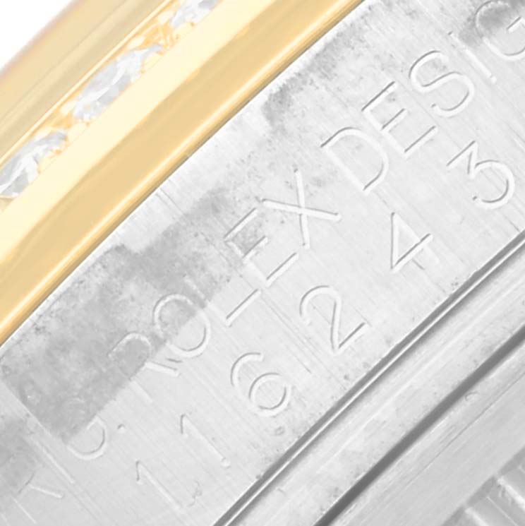 This close-up image shows the engraved case and diamond-studded gold bezel of the Rolex Datejust 116243 Men's Steel and Gold (two tone) Black Dial 116243 Men's Steel and Gold (two tone) Black Dial watch.