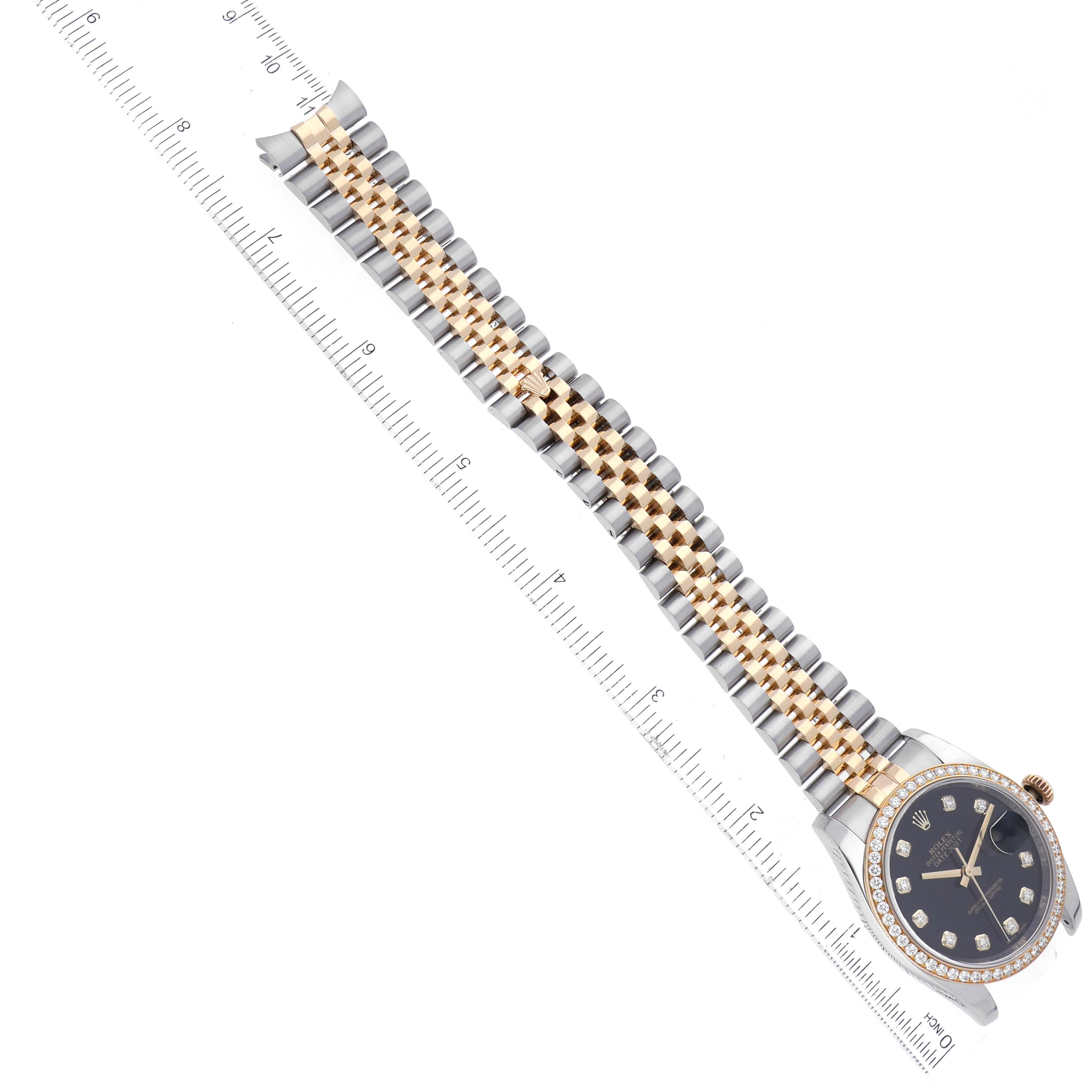 This image shows a Rolex Datejust 116243 Men's Steel and Gold (two tone) Black Dial 116243 Men's Steel and Gold (two tone) Black Dial watch at an angled top-down view, displaying the face and full bracelet with a ruler for scale.