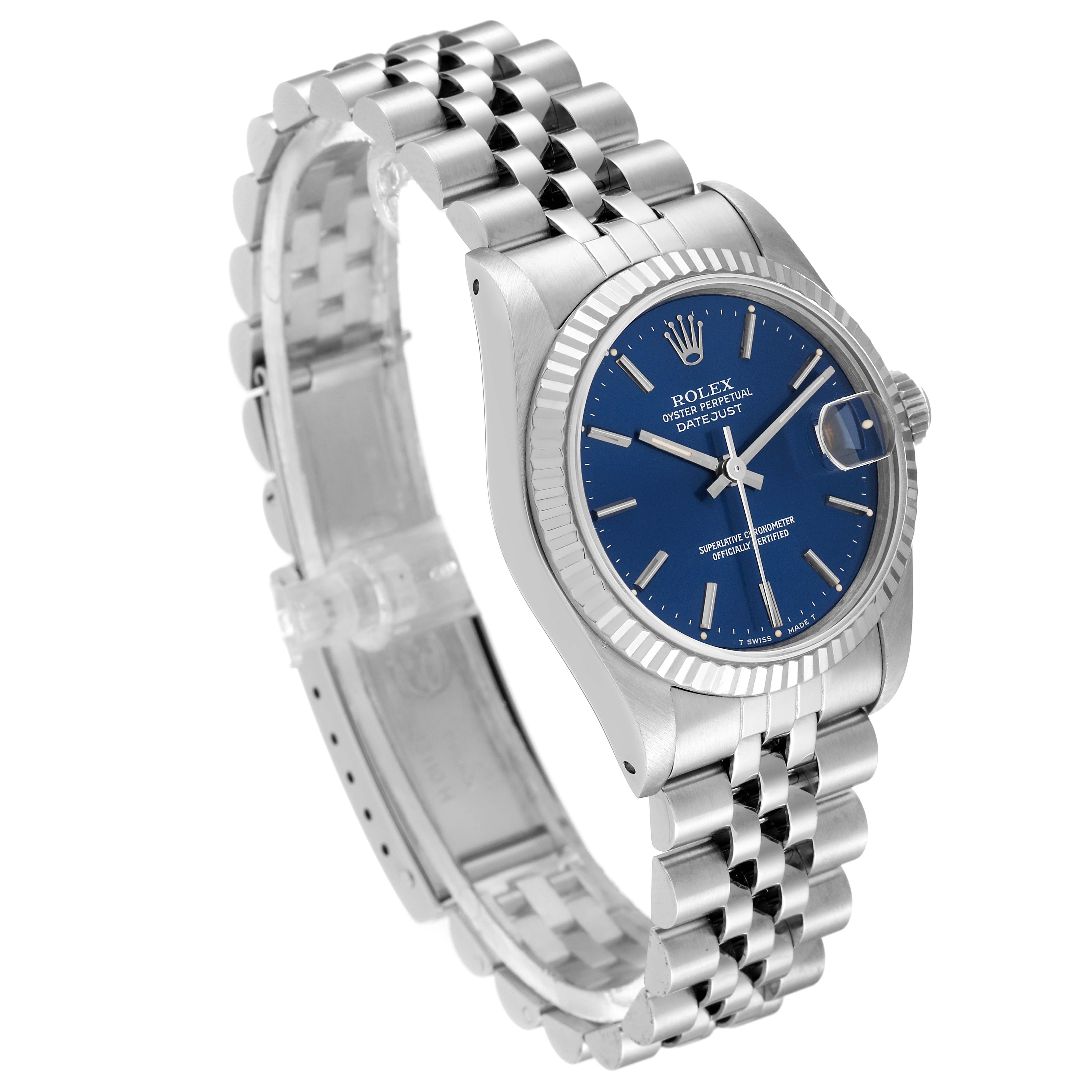 The image shows a Mid-Size Rolex Datejust watch from a three-quarter angle, highlighting its blue dial, fluted bezel, and Jubilee bracelet.