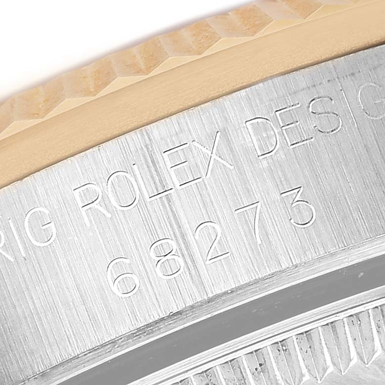 The image shows a close-up of the engraved case side of a Rolex Mid-Size 68273 Women's Steel and Gold (two tone) Champagne Dial model, highlighting the serial number and design text.