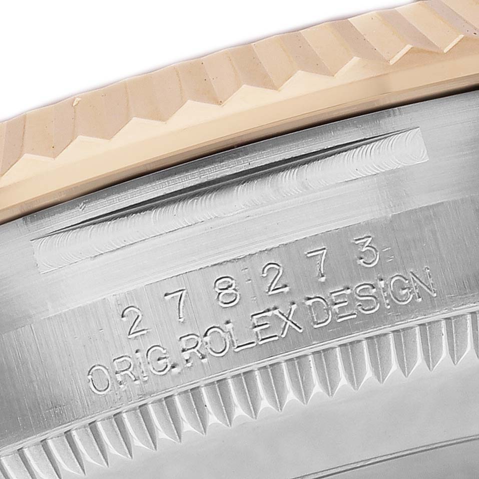 The image shows a close-up of the case back edge of a Rolex Mid-Size 278273 Women's Steel and Gold (two tone) Silver Dial watch, highlighting the engraved model number and fluted bezel.