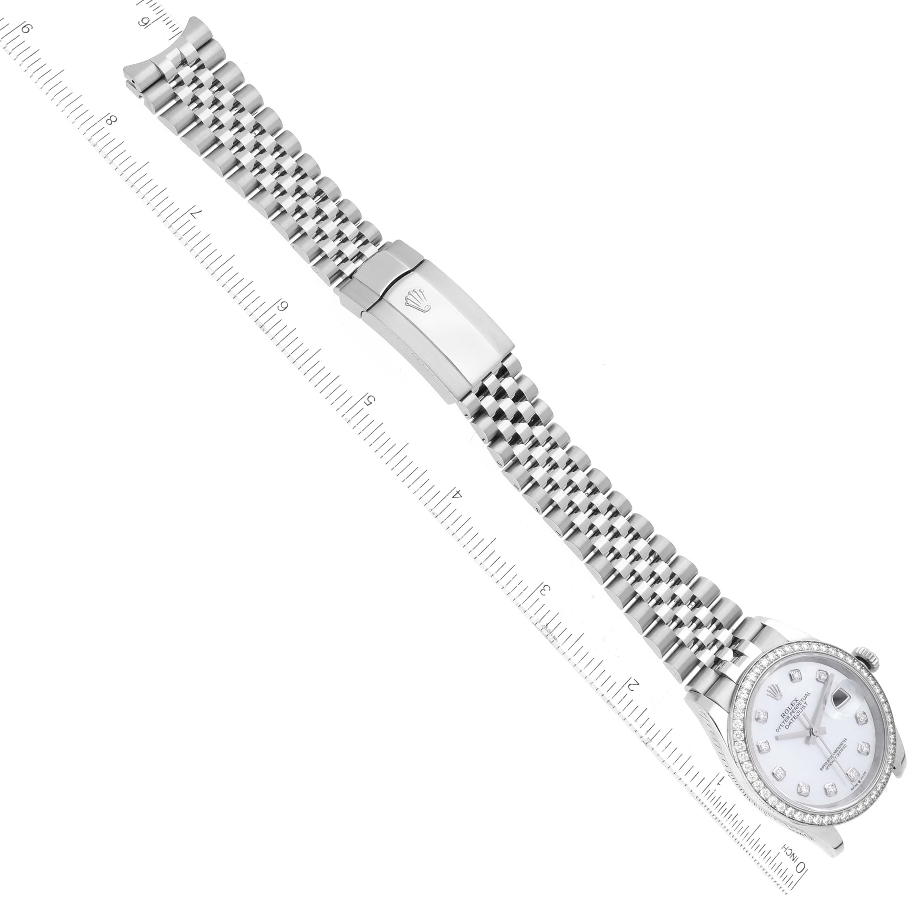 The image shows the Rolex Datejust 126284RBR Men's Stainless Steel Mother of Pearl Dial 126284RBR Men's Stainless Steel Mother of Pearl Dial watch with its full bracelet and clasp, displayed next to a ruler.