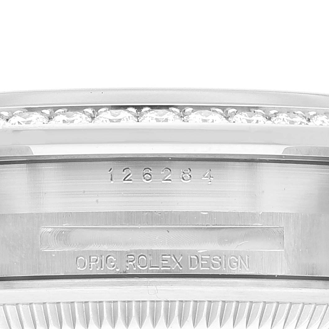 Close-up of the case side of a Rolex Datejust 126284 Men's Stainless Steel Silver Dial 126284 Men's Stainless Steel Silver Dial, showing the model number, design markings, and part of the diamond bezel.