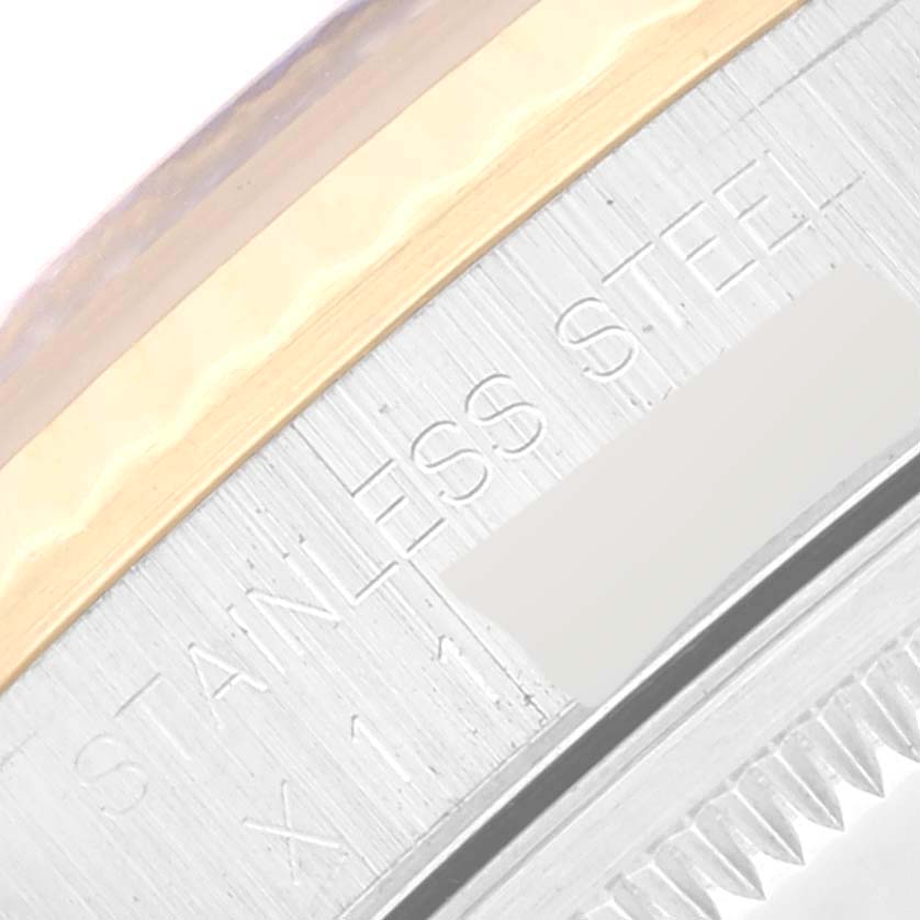 This image shows a close-up view of the stainless steel and engravings on the bezel of a Rolex Datejust 16233 Men's Steel and Gold (two tone) Black Dial 16233 Men's Steel and Gold (two tone) Black Dial watch.