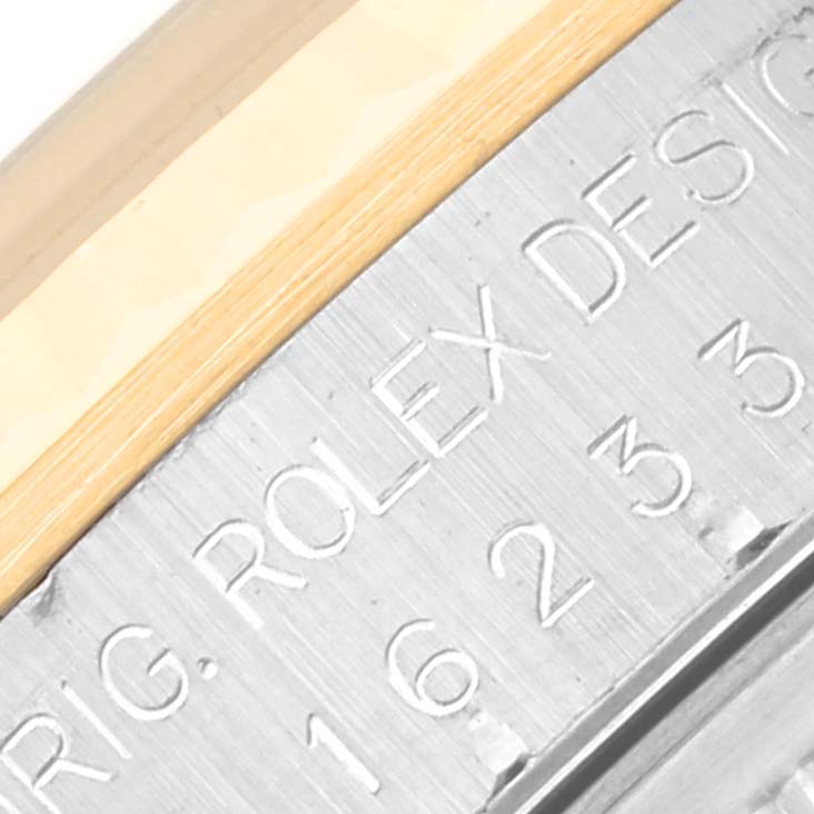 The image shows a close-up angle of the inner bezel and the case of a Rolex Datejust 16233 Men's Steel and Gold (two tone) White Dial 16233 Men's Steel and Gold (two tone) White Dial, highlighting engraved text and model numbers.
