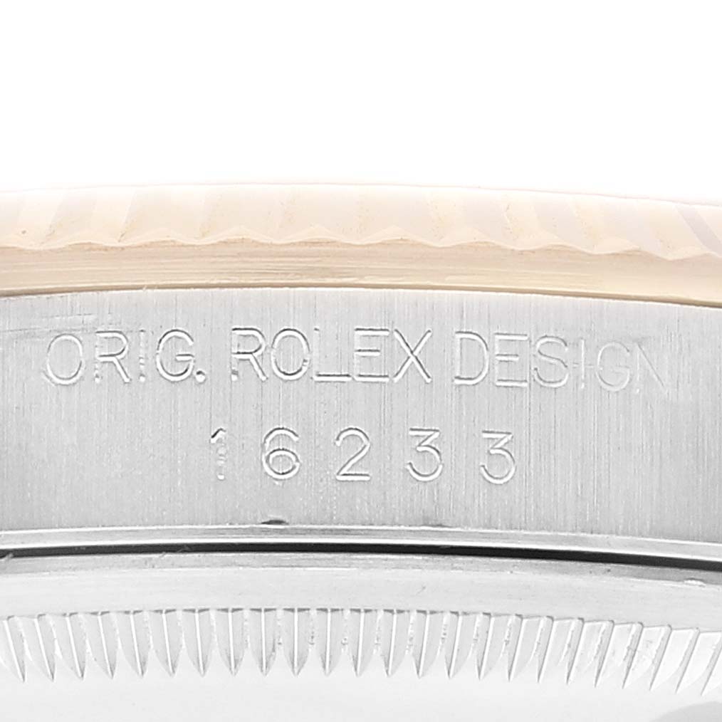 This image shows a close-up of the side of the Rolex Datejust 16233 Men's Steel and Gold (two tone) Beige Dial 16233 Men's Steel and Gold (two tone) Beige Dial case, featuring the model number 16233 and "ORIG. ROLEX DESIGN" engraving.
