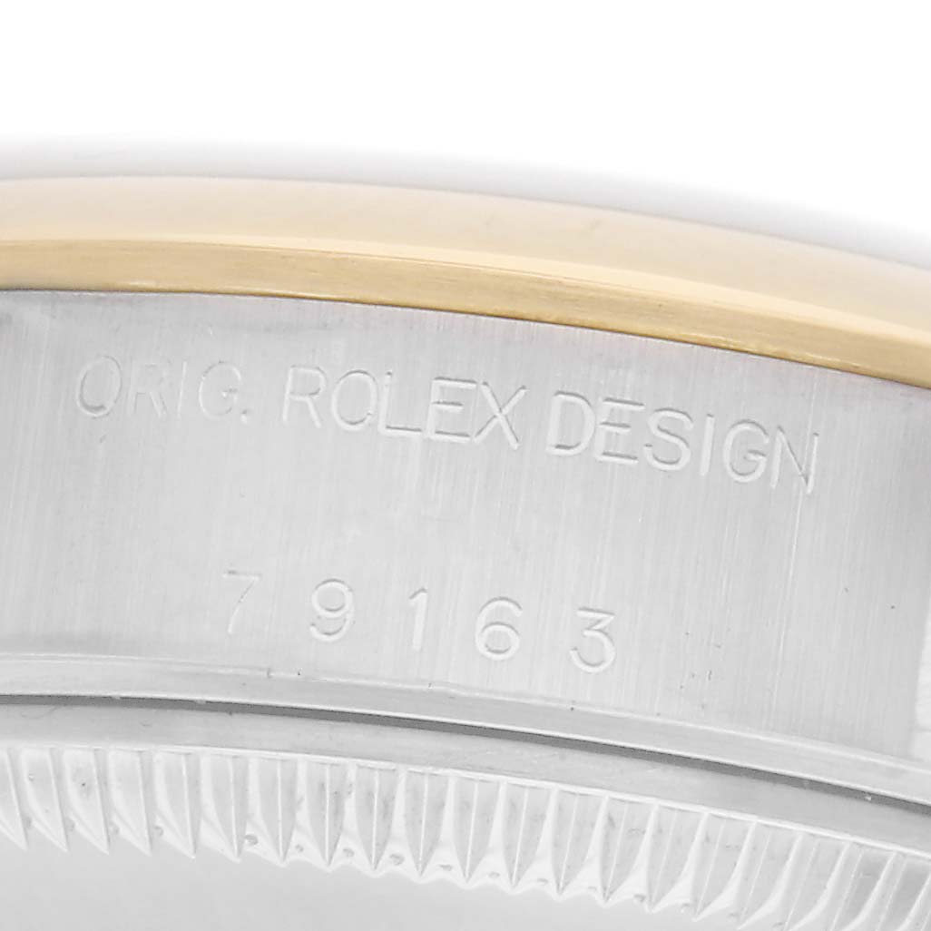 The image shows a close-up of a Rolex Datejust model 79163, focusing on the engraved side of the watch case, displaying "ORIG. ROLEX DESIGN" and "79163".