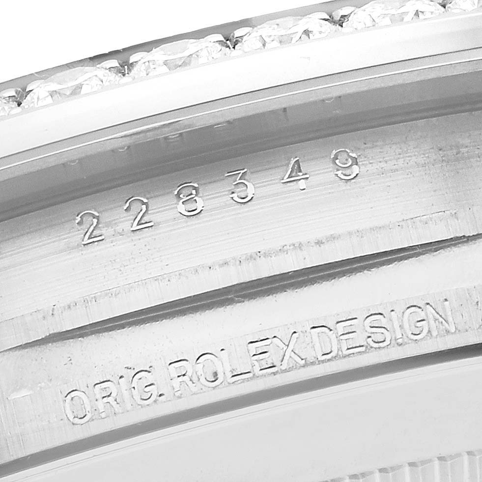 Close-up of the serial number and "ORIG. ROLEX DESIGN" engraving on a Rolex President 228349 Men's White Gold Green Dial 228349 Men's White Gold Green Dial model bezel.
