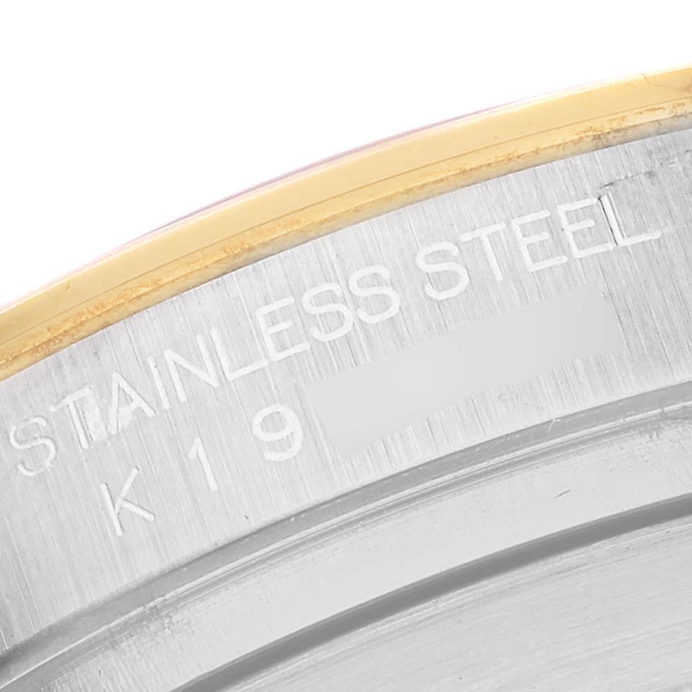 This image shows a close-up angle of the stainless steel caseback edge of a Rolex Daytona 116523 Men
s Steel and Gold (two tone) Champagne Dial 116523 Men
s Steel and Gold (two tone) Champagne Dial watch.