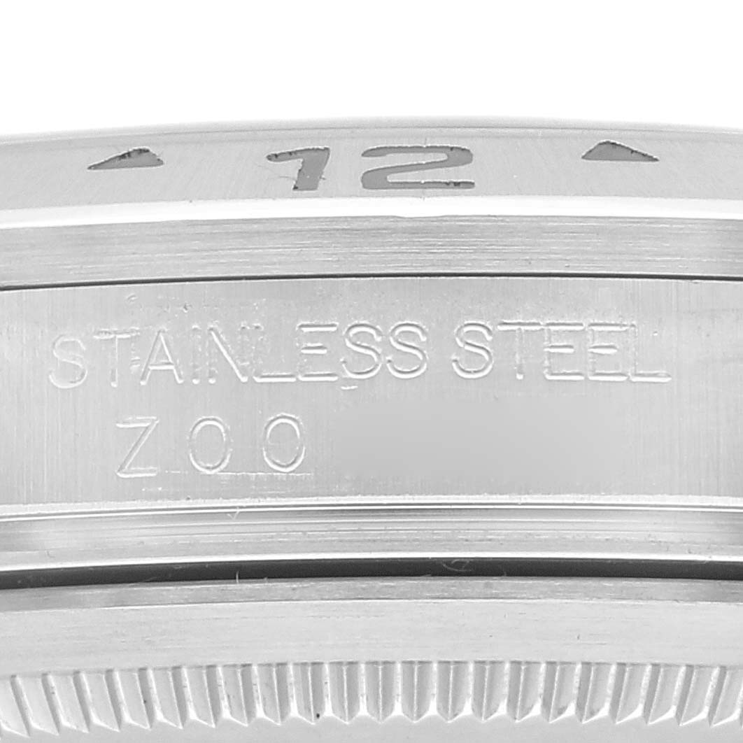 The image shows a close-up view of the engraved bezel and stainless steel case back of a Rolex Explorer 16570 Men
s Stainless Steel White Dial 16570 Men
s Stainless Steel White Dial model watch.