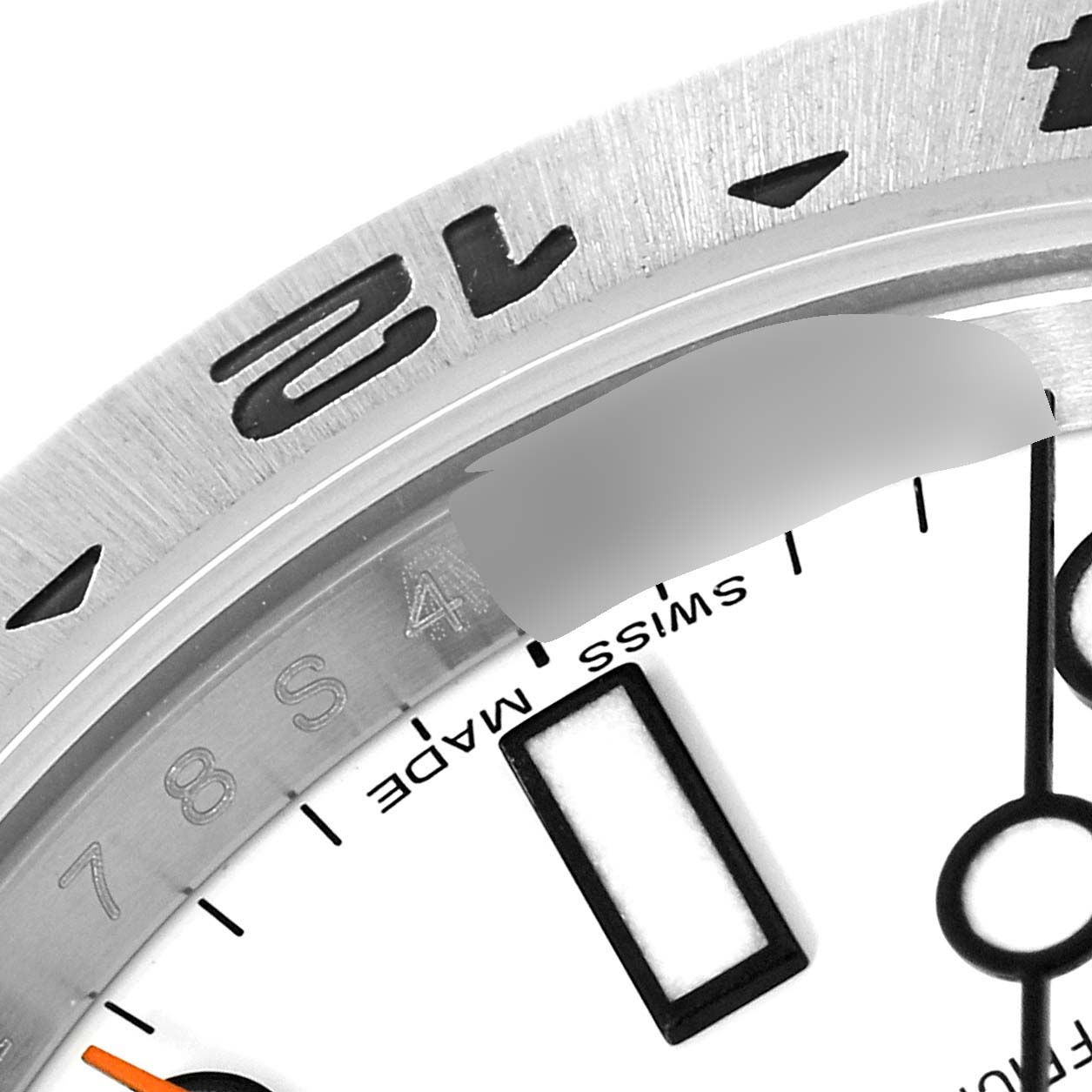 This close-up image shows the bezel, part of the dial, and indices of a Rolex Explorer 216570 Men
s Stainless Steel White Dial 216570 Men
s Stainless Steel White Dial watch.