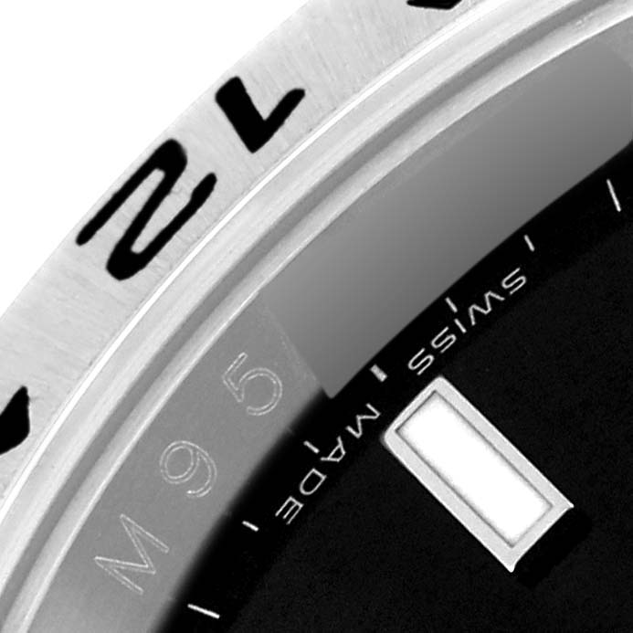 This close-up image shows a partial view of the bezel and dial of a Rolex Explorer 16570T Men
s Stainless Steel Black Dial 16570T Men
s Stainless Steel Black Dial watch.