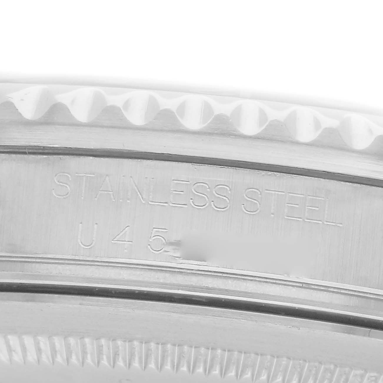 The image shows a close-up of the side of the Rolex GMT-Master model 16710, highlighting the stainless steel case and engraved details.