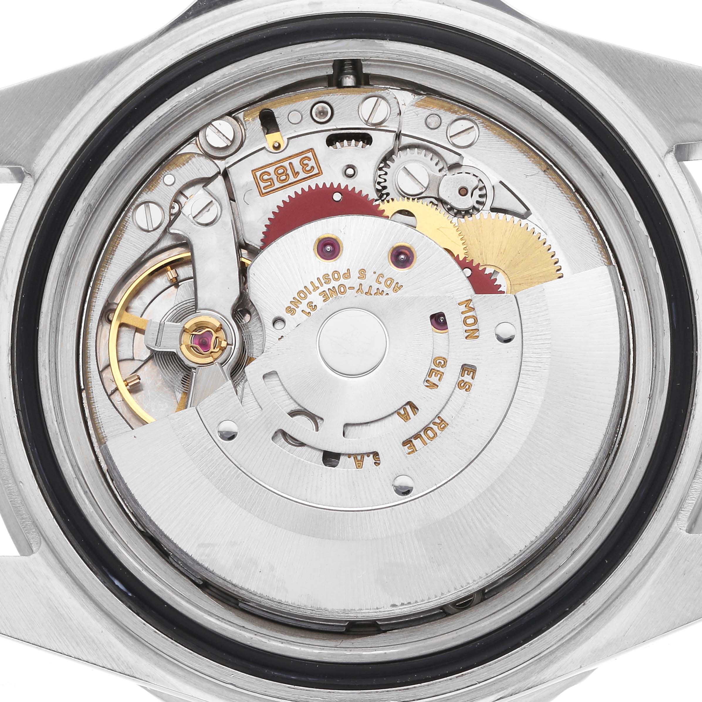 The image shows the movement of a Rolex GMT-Master model 16710 from the back, highlighting gears and components intricately arranged.