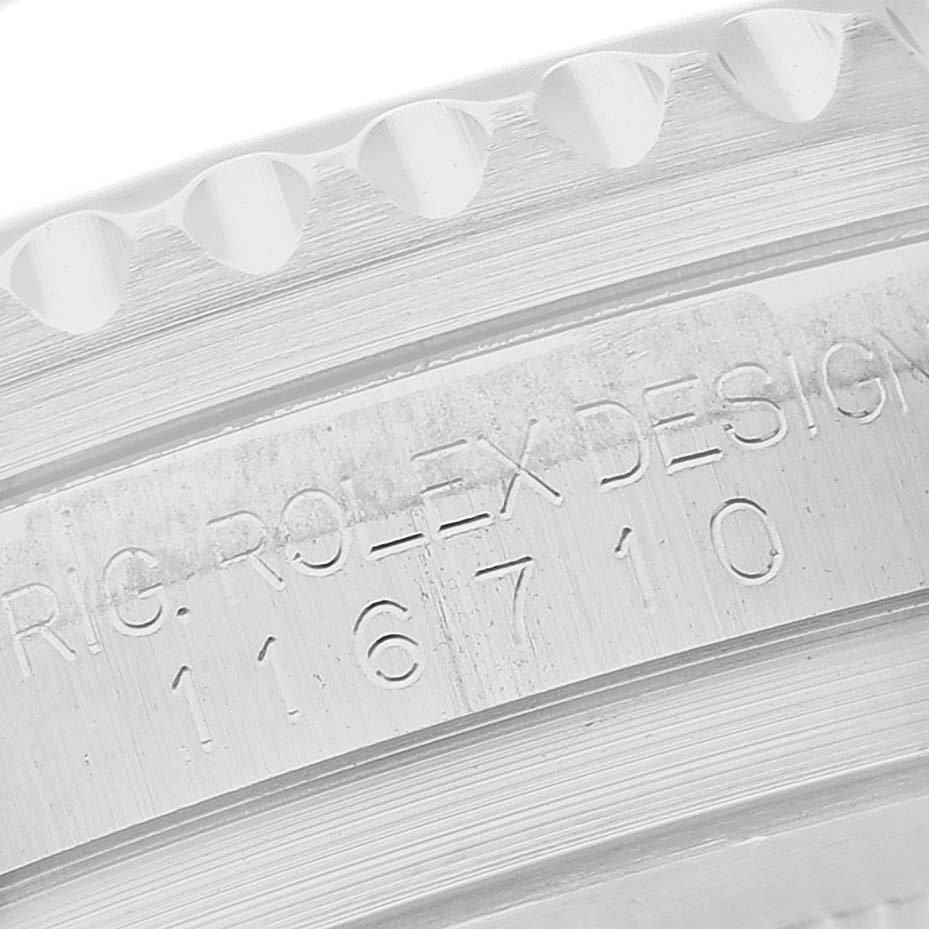 The image shows a close-up of the engraved inner bezel of a Rolex GMT-Master 116710 Men's Stainless Steel Black Dial, featuring the model number and design details.