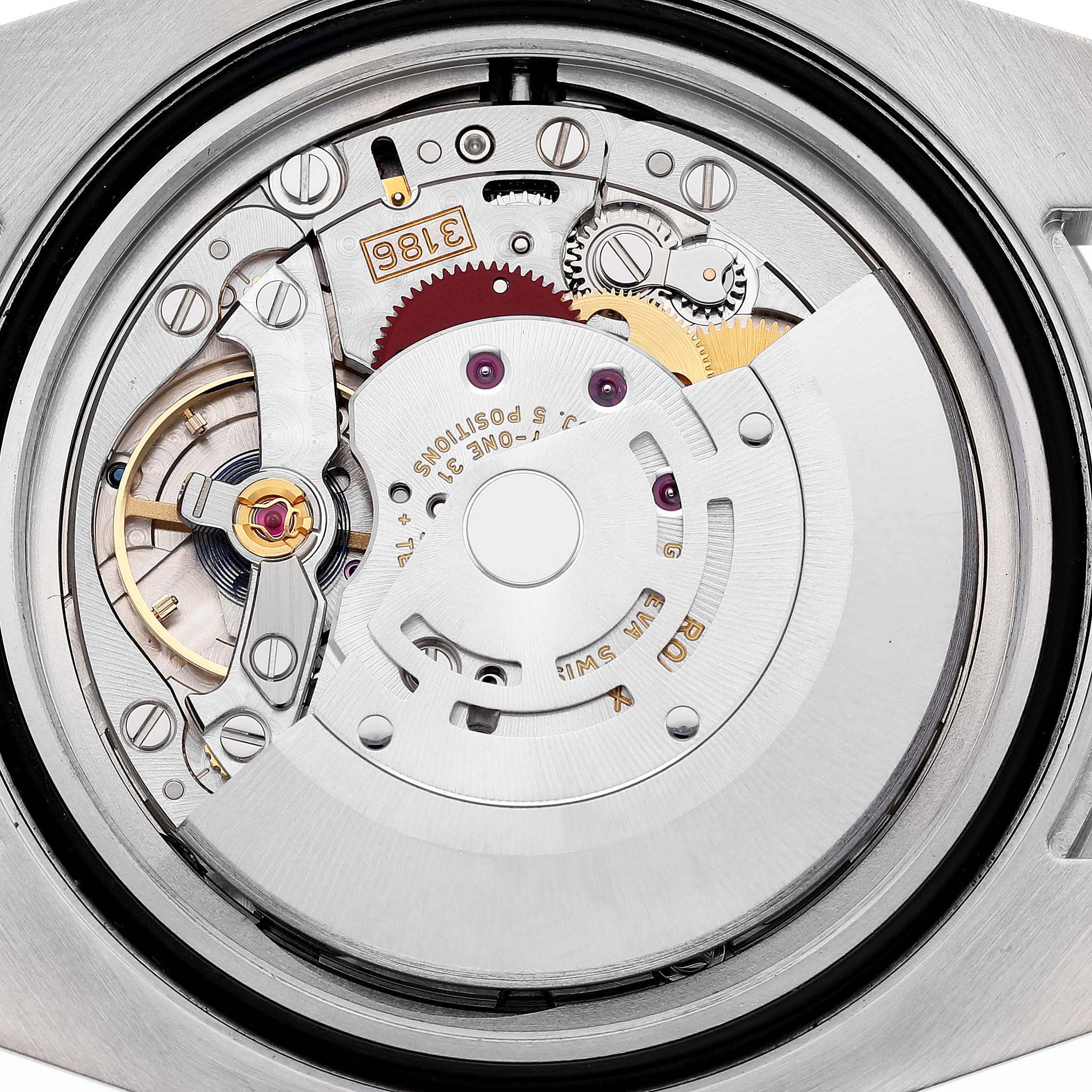 The image shows the movement of a Rolex GMT-Master 116713LN Men's Steel and Gold (two tone) Black Dial watch viewed from the back, highlighting gears and the rotor.