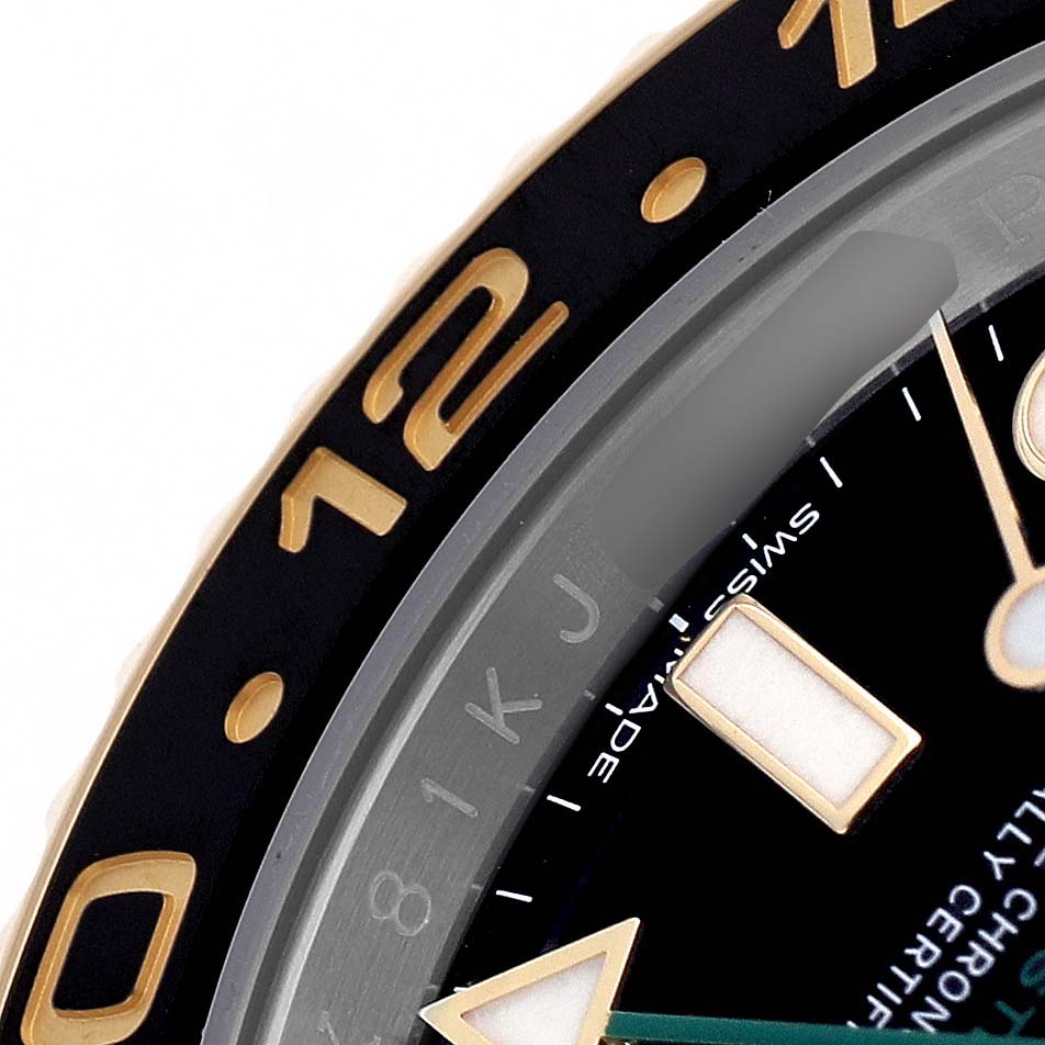 The image shows a close-up of the Rolex GMT-Master 116713LN Men's Steel and Gold (two tone) Black Dial bezel and part of the dial with hour markers and hands.