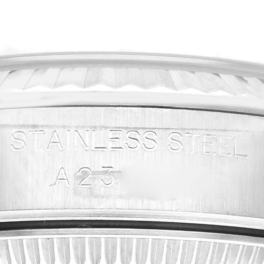 This image shows a close-up of the Rolex Oyster Perpetual 76094 Women's Stainless Steel White Dial 76094 Women's Stainless Steel White Dial watch, focusing on the stainless steel casing and engraved details.